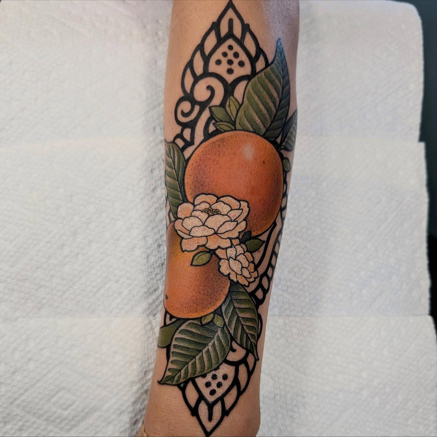 Orange and flowers American traditional tattoo on the forearm by English Cousins, Nashville, Tennessee