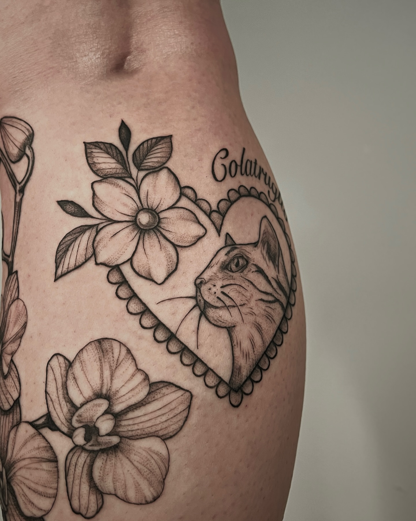 Cat and flowers realism tattoo on the thigh by Mikayla Sue