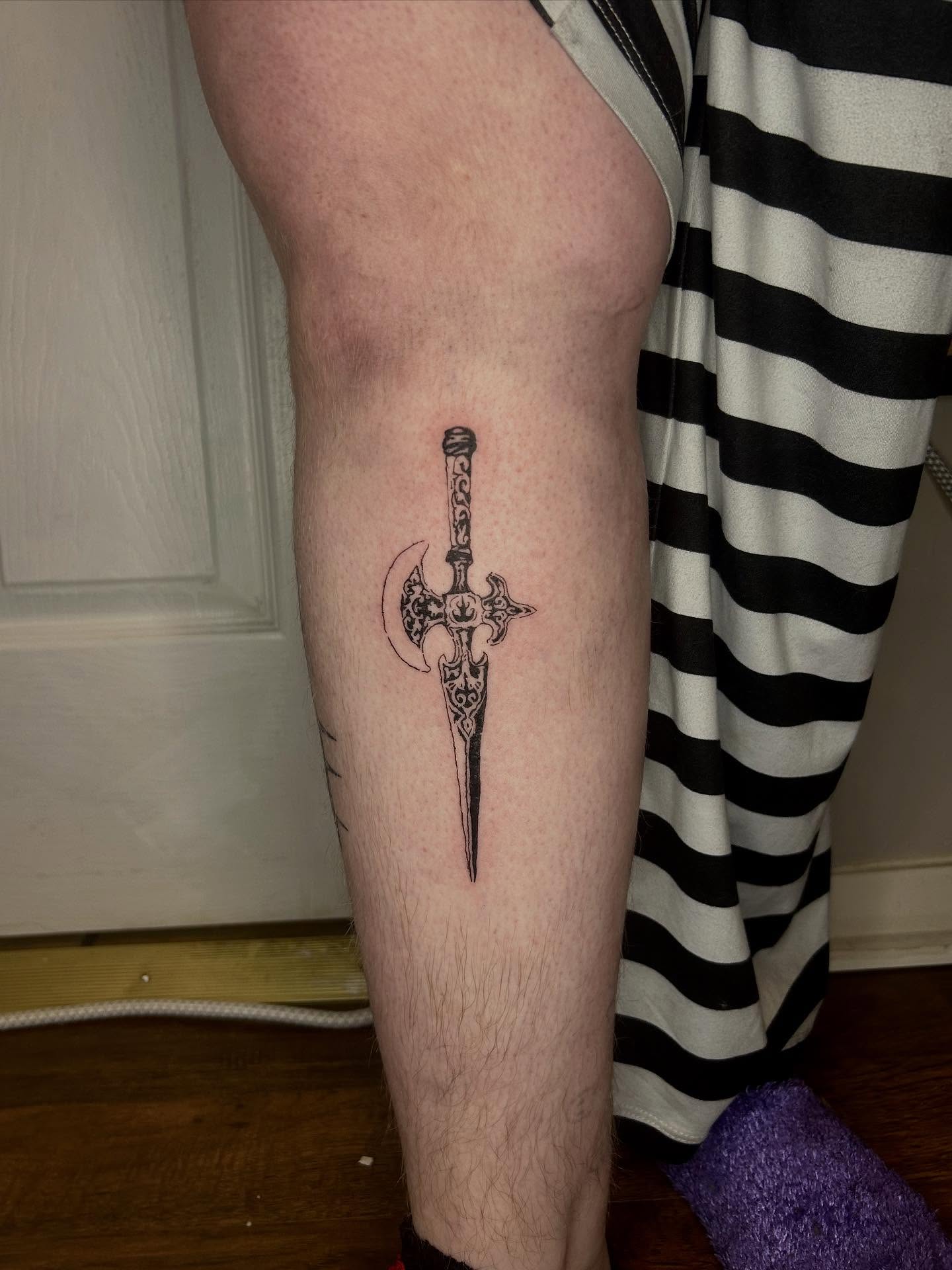 Crossed axe and dagger black and grey tattoo on the leg by (isa)ac ૮₍ ˃̵ࡇ˂̵ ₎ა