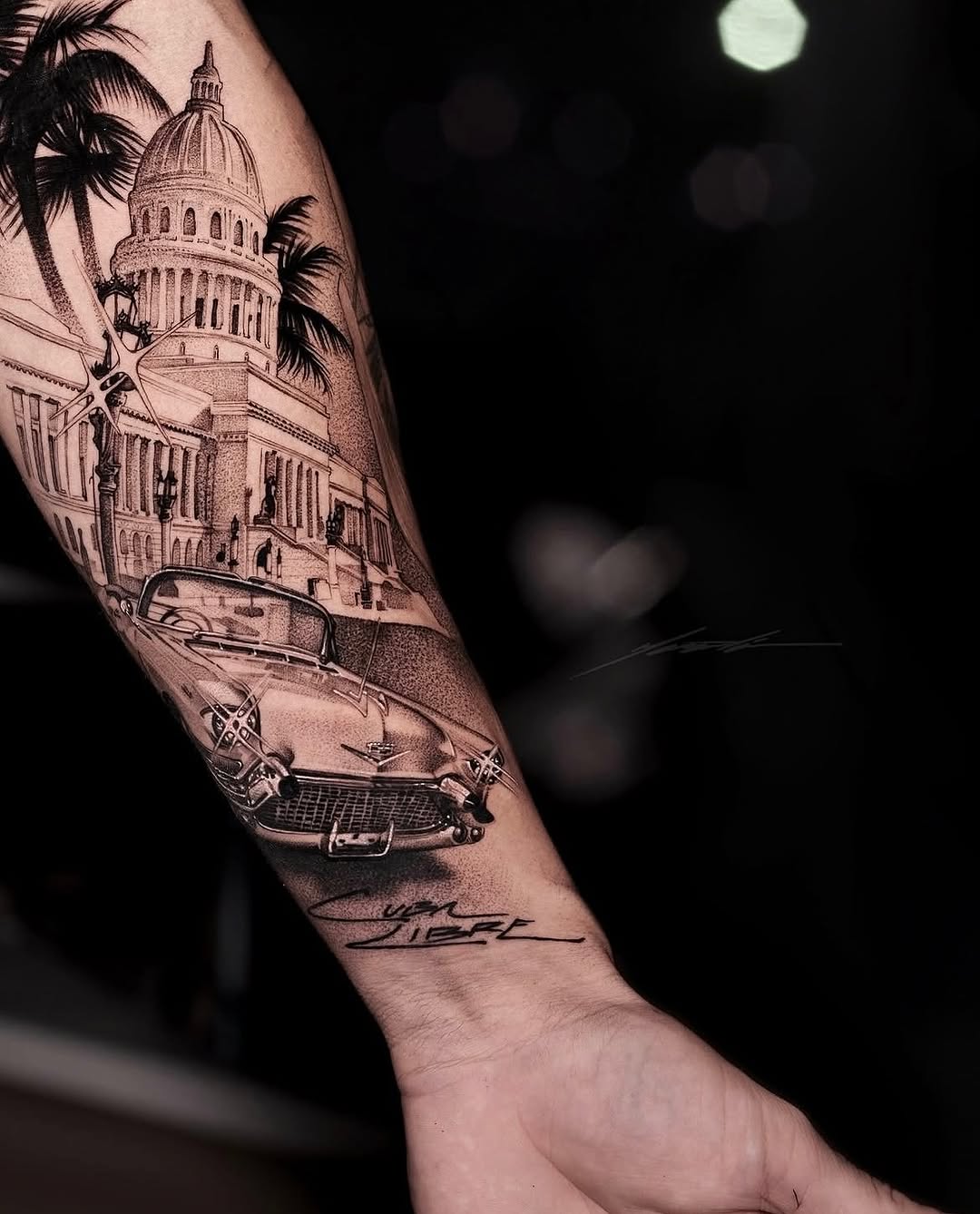 Classic car and building Chicano tattoo on the forearm by Ke$la