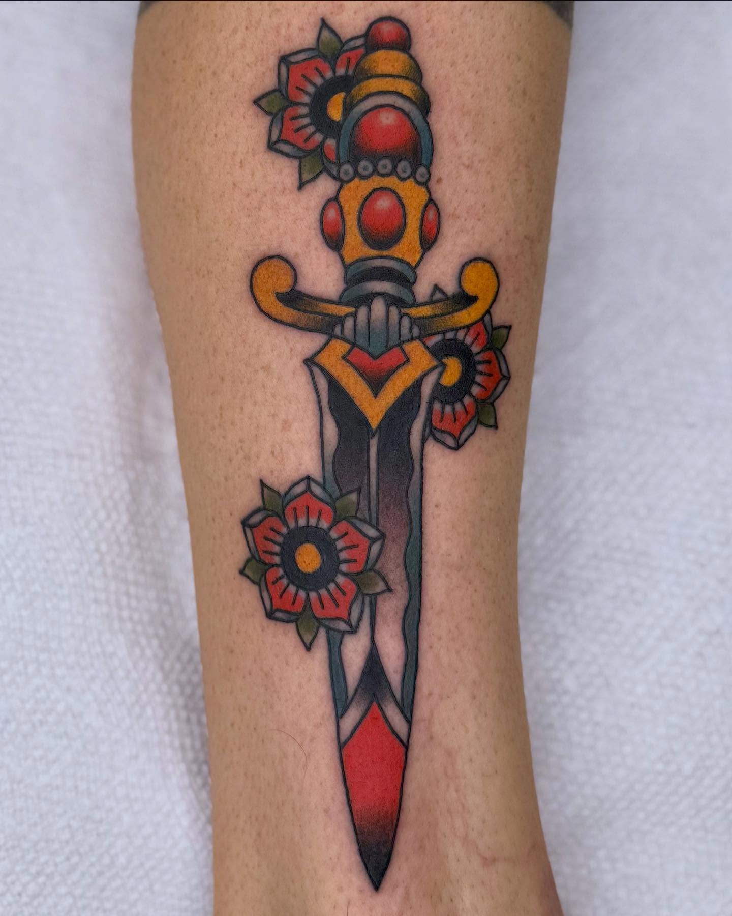 Sword and flowers American traditional tattoo on the forearm by Curtis Stairs, Seattle, Washington