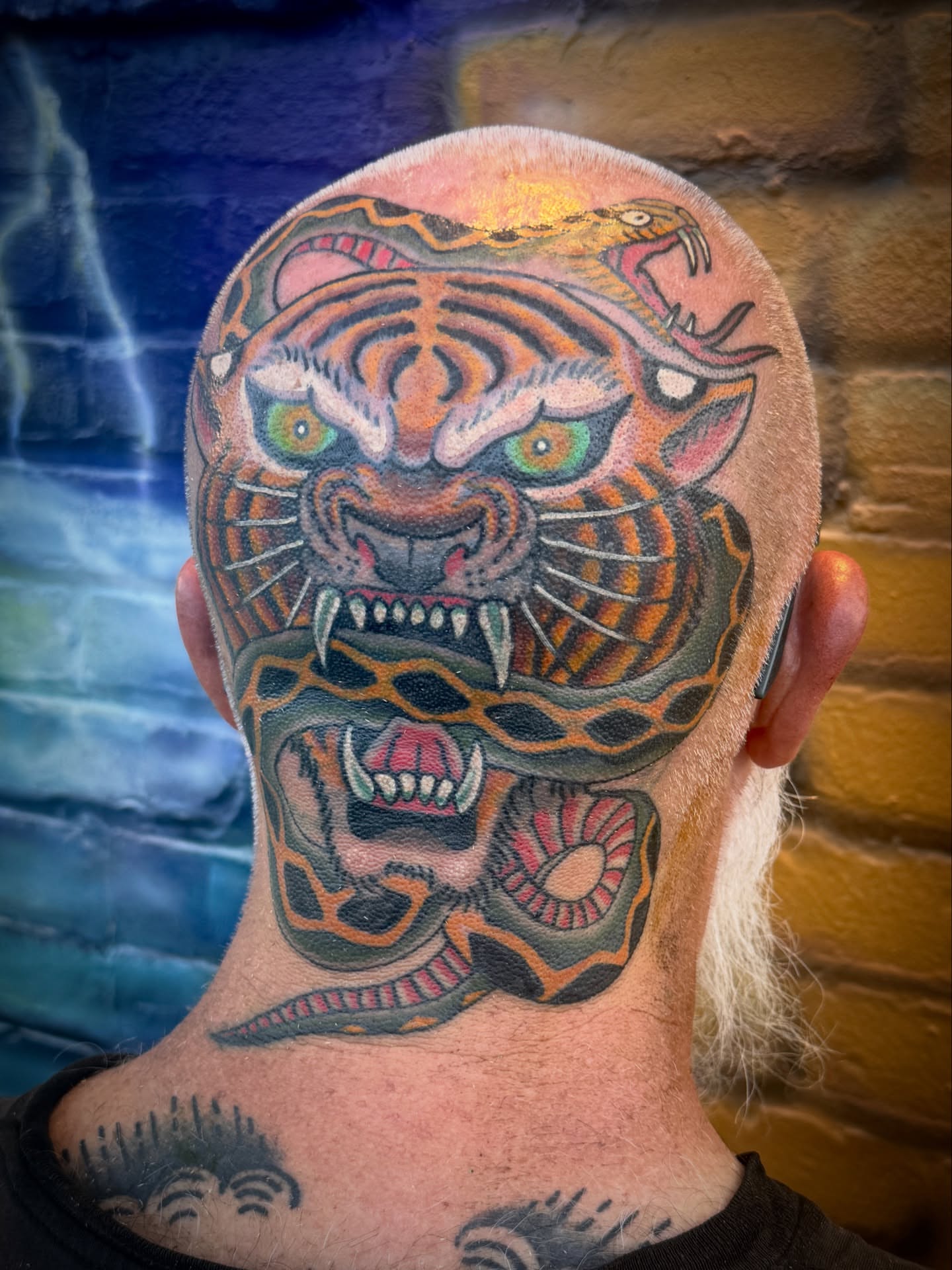 Tiger and snake American traditional tattoo on the neck by Drew McElveney, Austin, Texas
