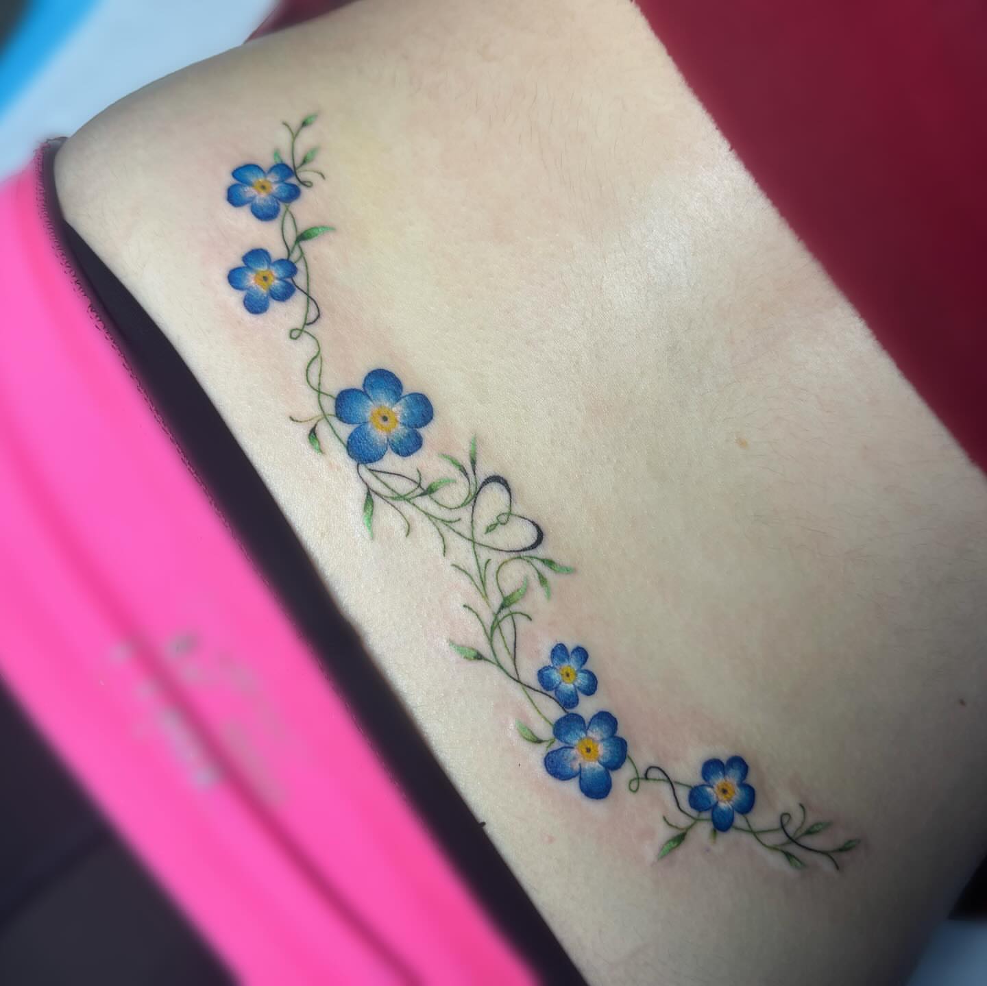 Blue forget-me-not flowers dotwork tattoo on the forearm by Elly Bordwell