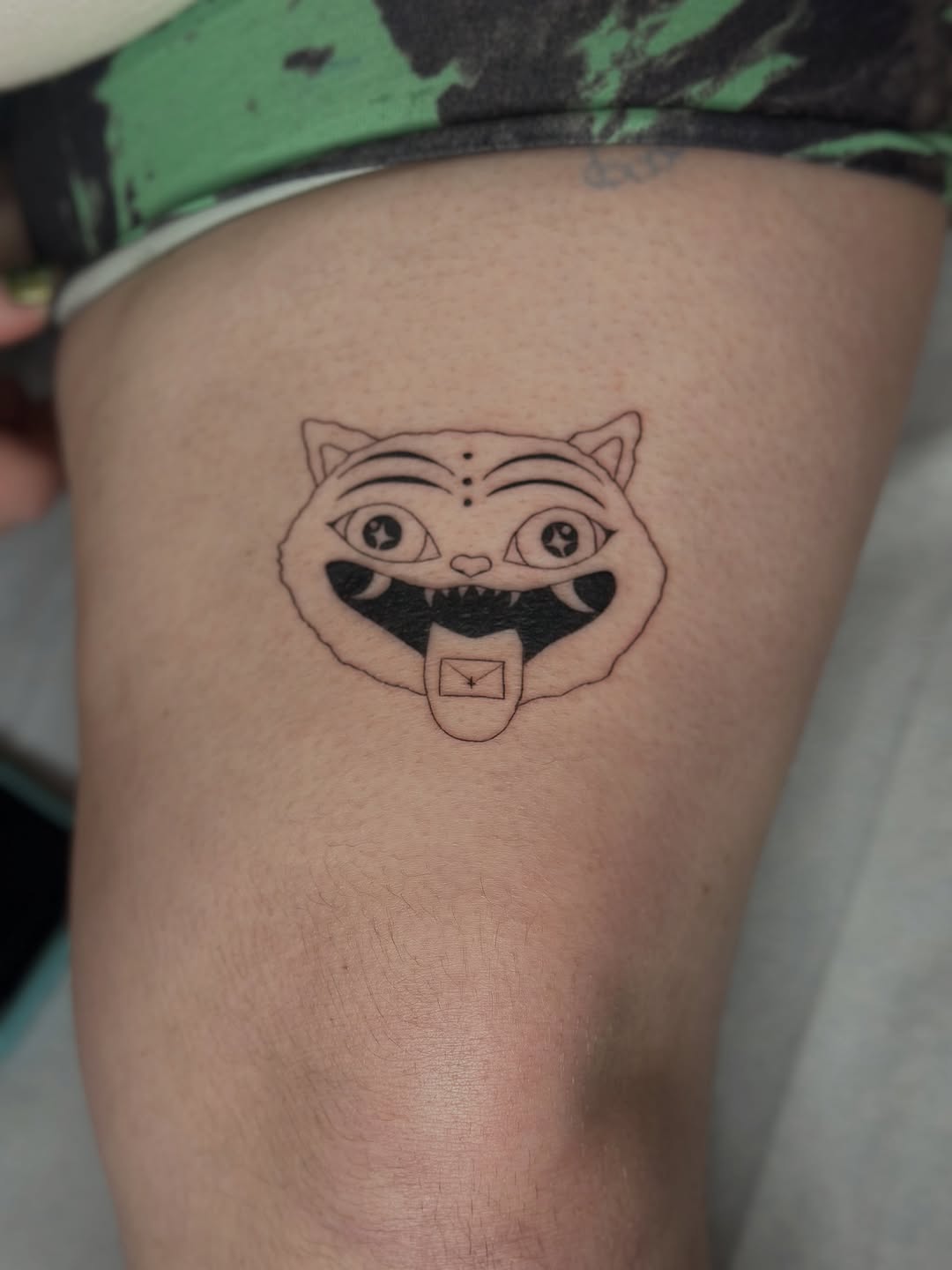 Cat face with envelope tongue realism tattoo on the thigh by Cherry🥀