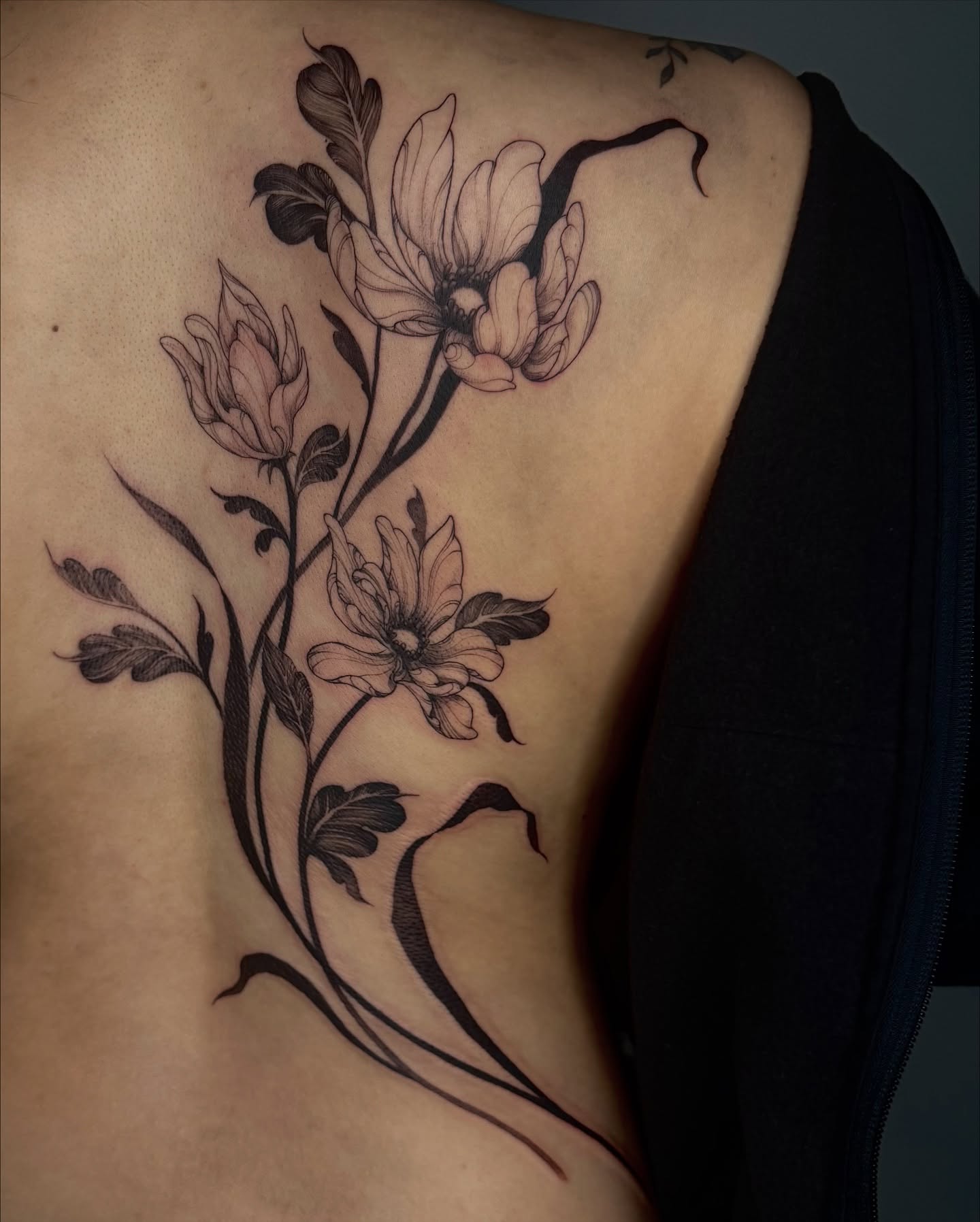 Floral arrangement black and grey tattoo on the ribs by Sab