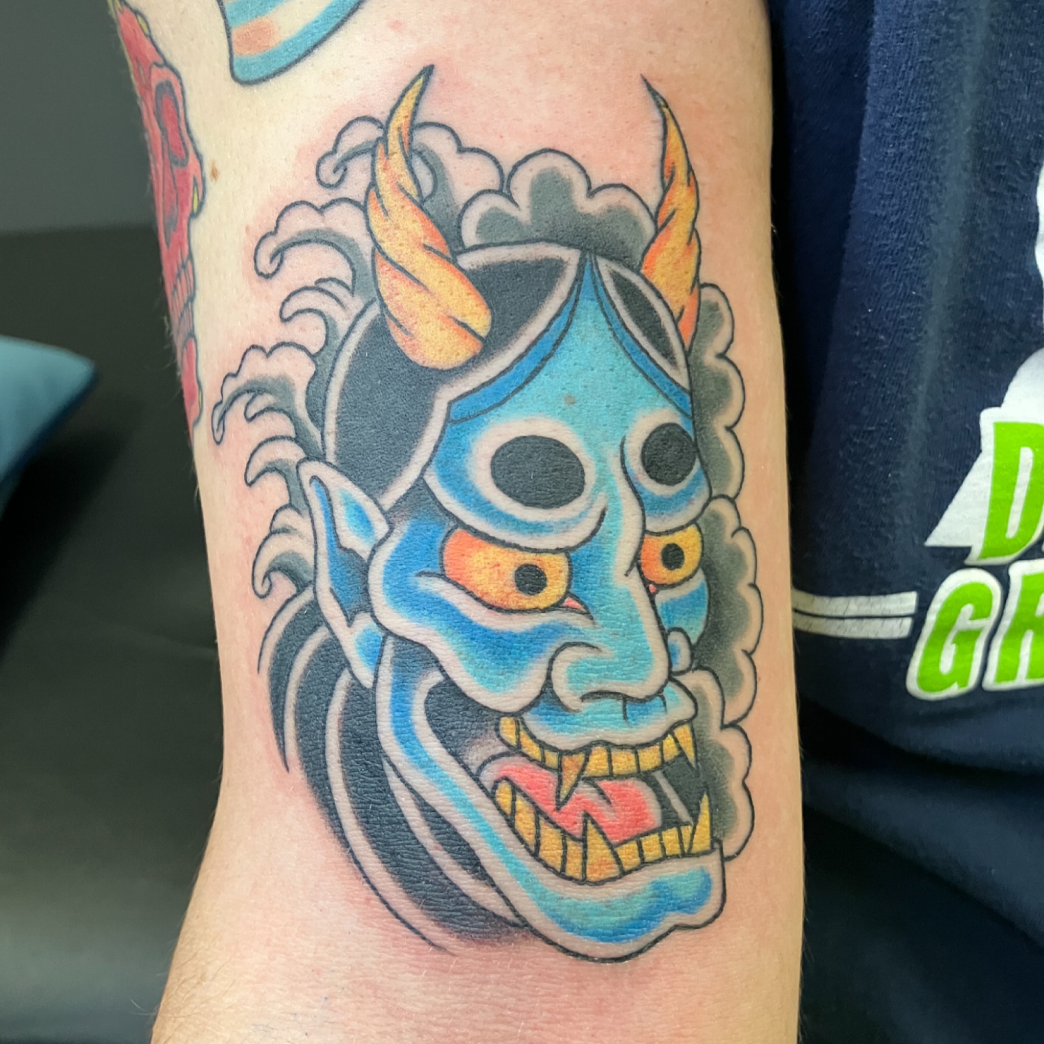 Demon mask American traditional tattoo on the forearm by maddie mcghee, Memphis, Tennessee