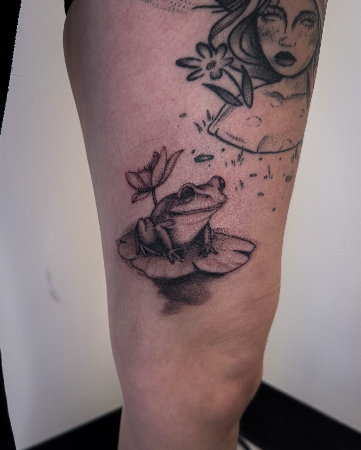 Frog and lily pad dotwork tattoo on the thigh by utah tattoo artist
