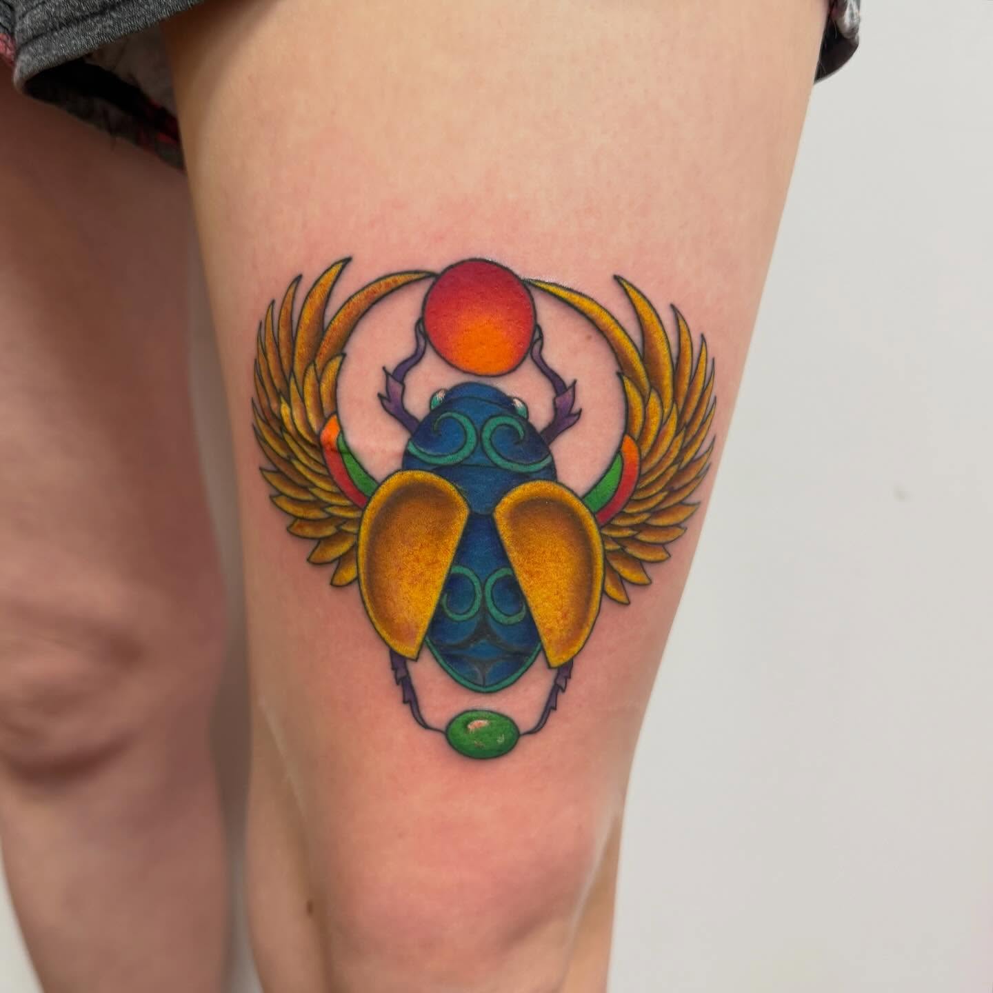 Scarab beetle geometric tattoo on the thigh by McKenna Chalifoux