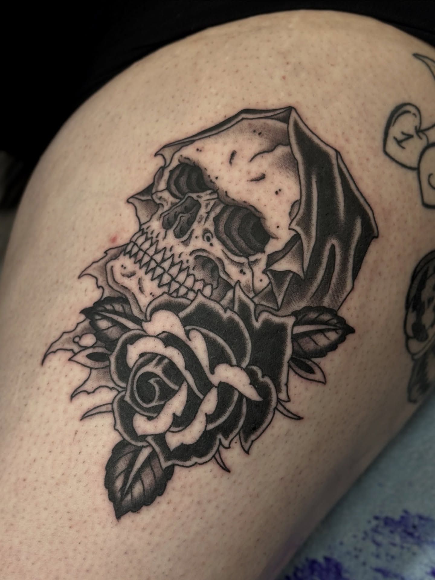 Skull and rose realism tattoo on the thigh by Christopher  Cousins, Nashville, Tennessee