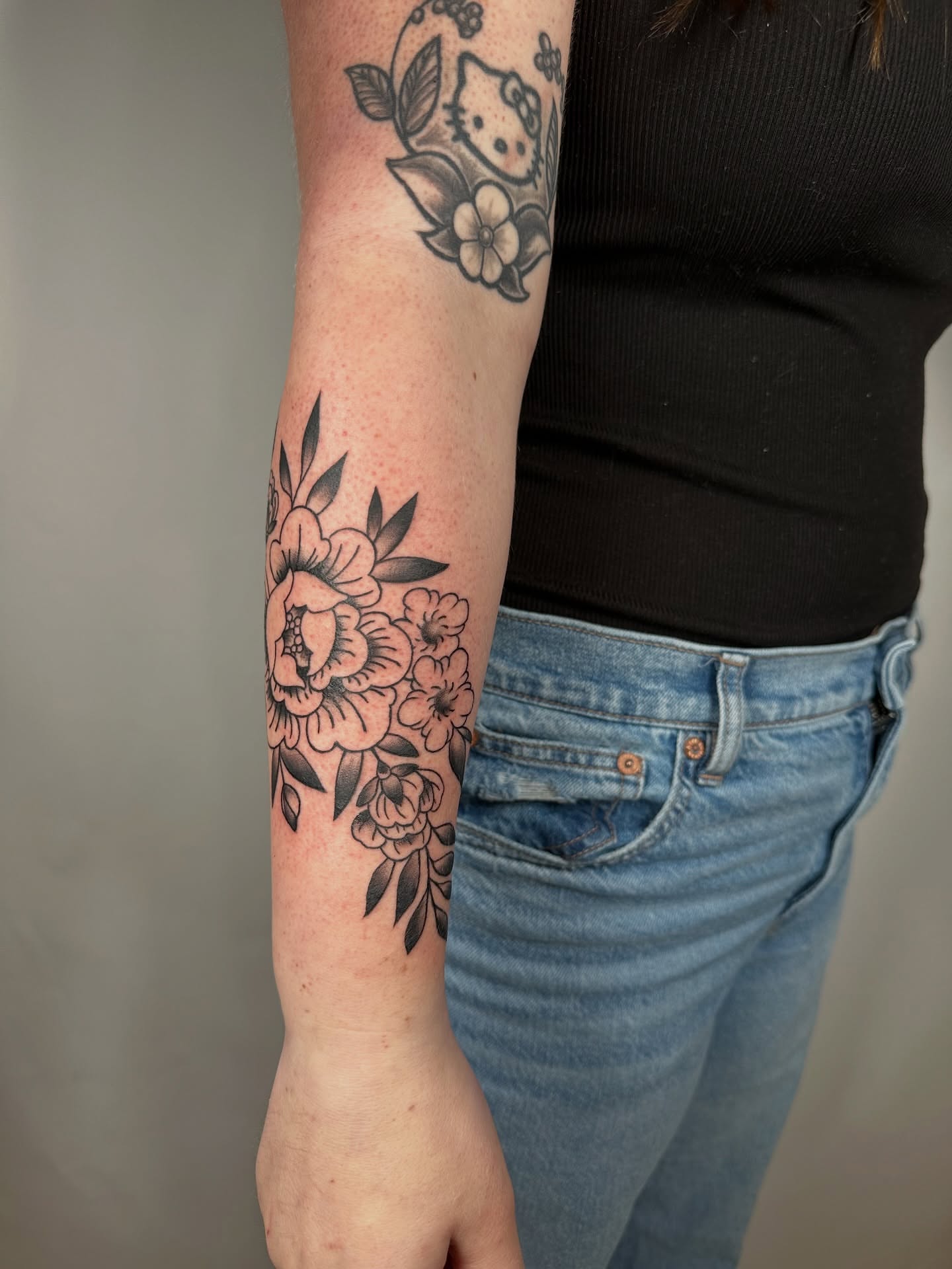 Floral bouquet black and grey tattoo on the forearm by Heather Cherish