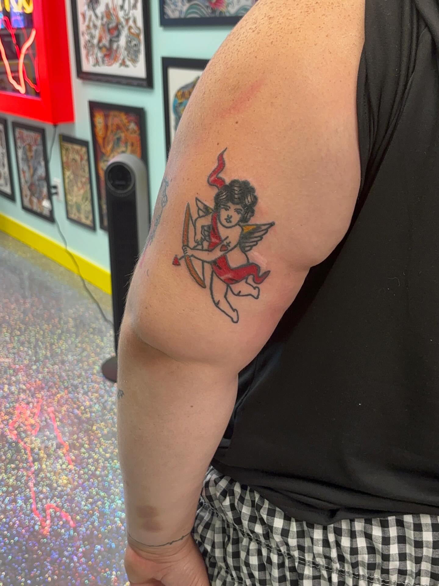 Cherub American traditional tattoo on the forearm by Nyah Ramirez