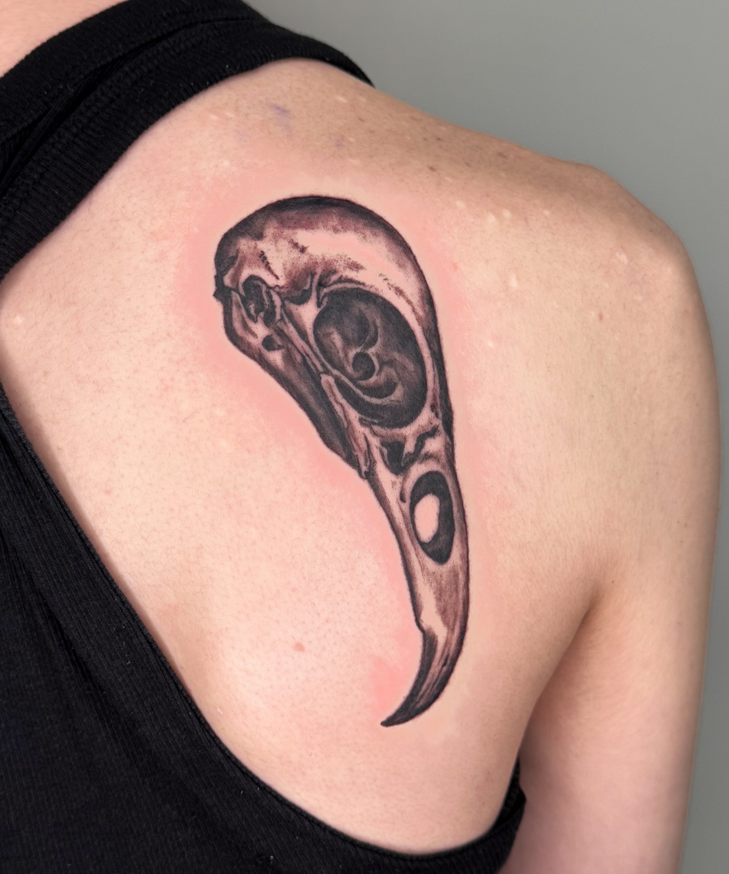 Skull black and grey tattoo on the shoulder by Tiffany
