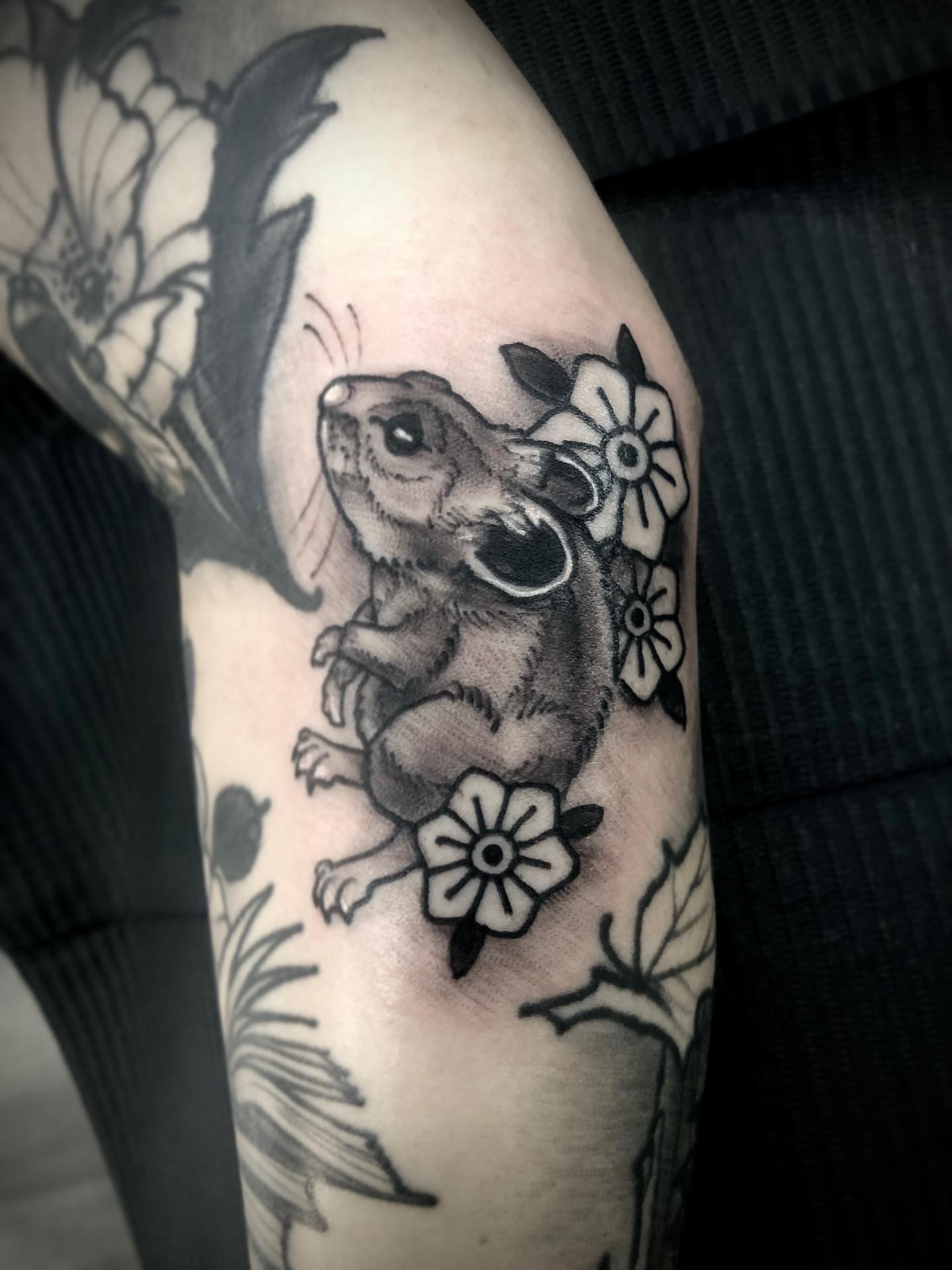 Chinchilla and flowers black and grey tattoo on the forearm by Alec Bauer