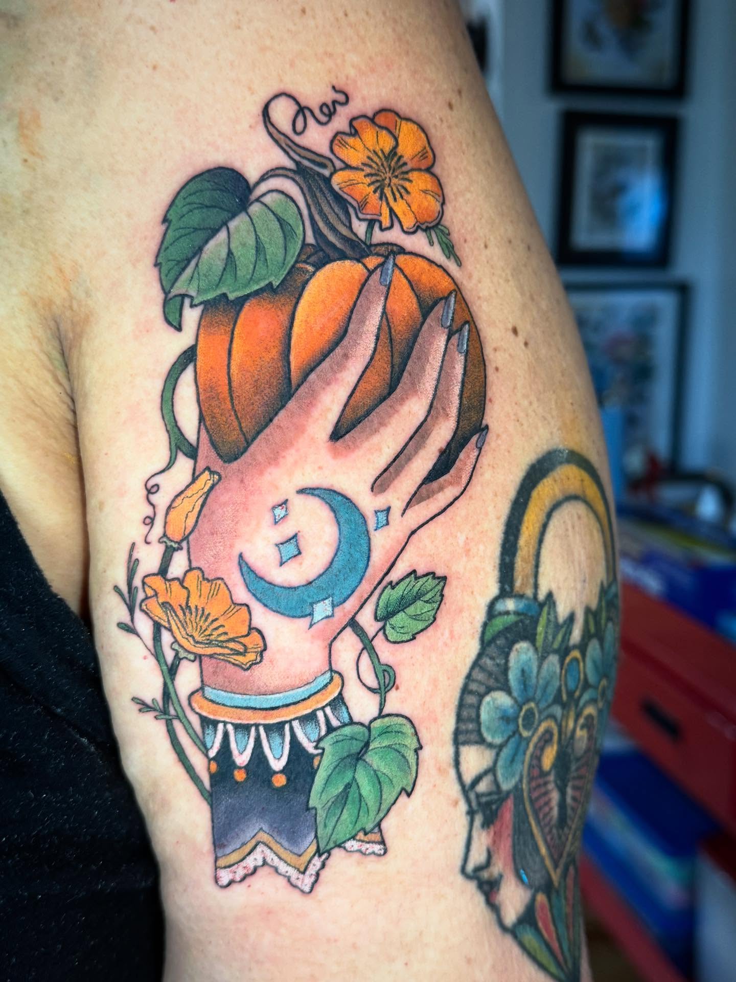 Pumpkin and hand American traditional tattoo on the thigh by Katy Bisby