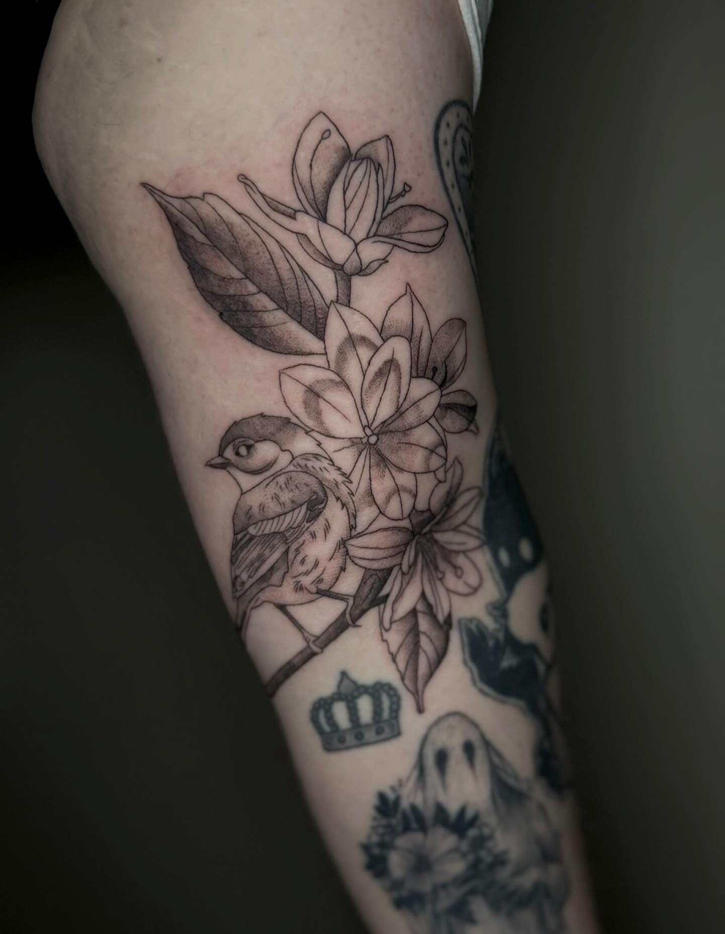 Bird and flowers black and grey tattoo on the forearm by Brandi 🕷, Mentor, Ohio