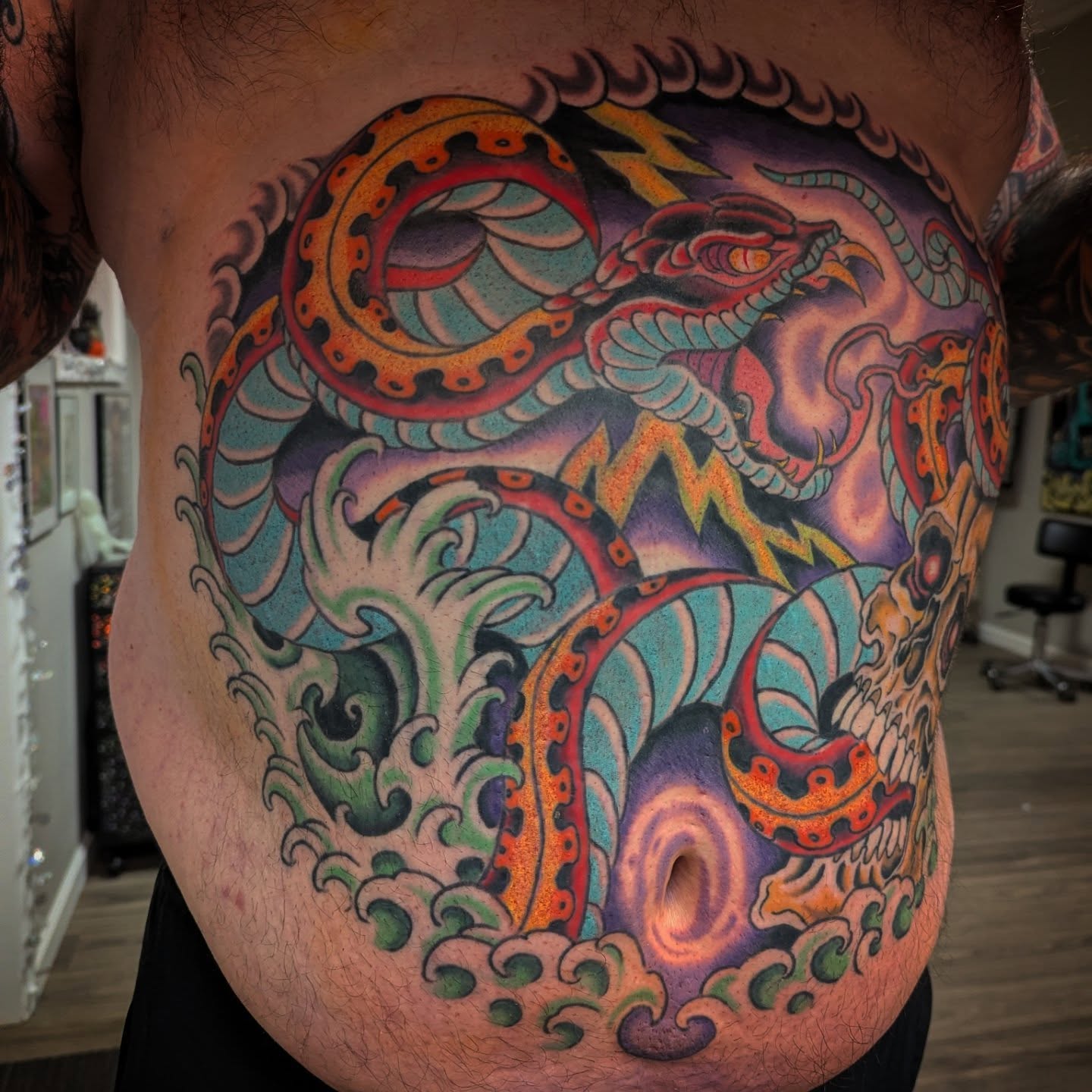 Serpent and skull new school tattoo on the chest by Ryan Slegel