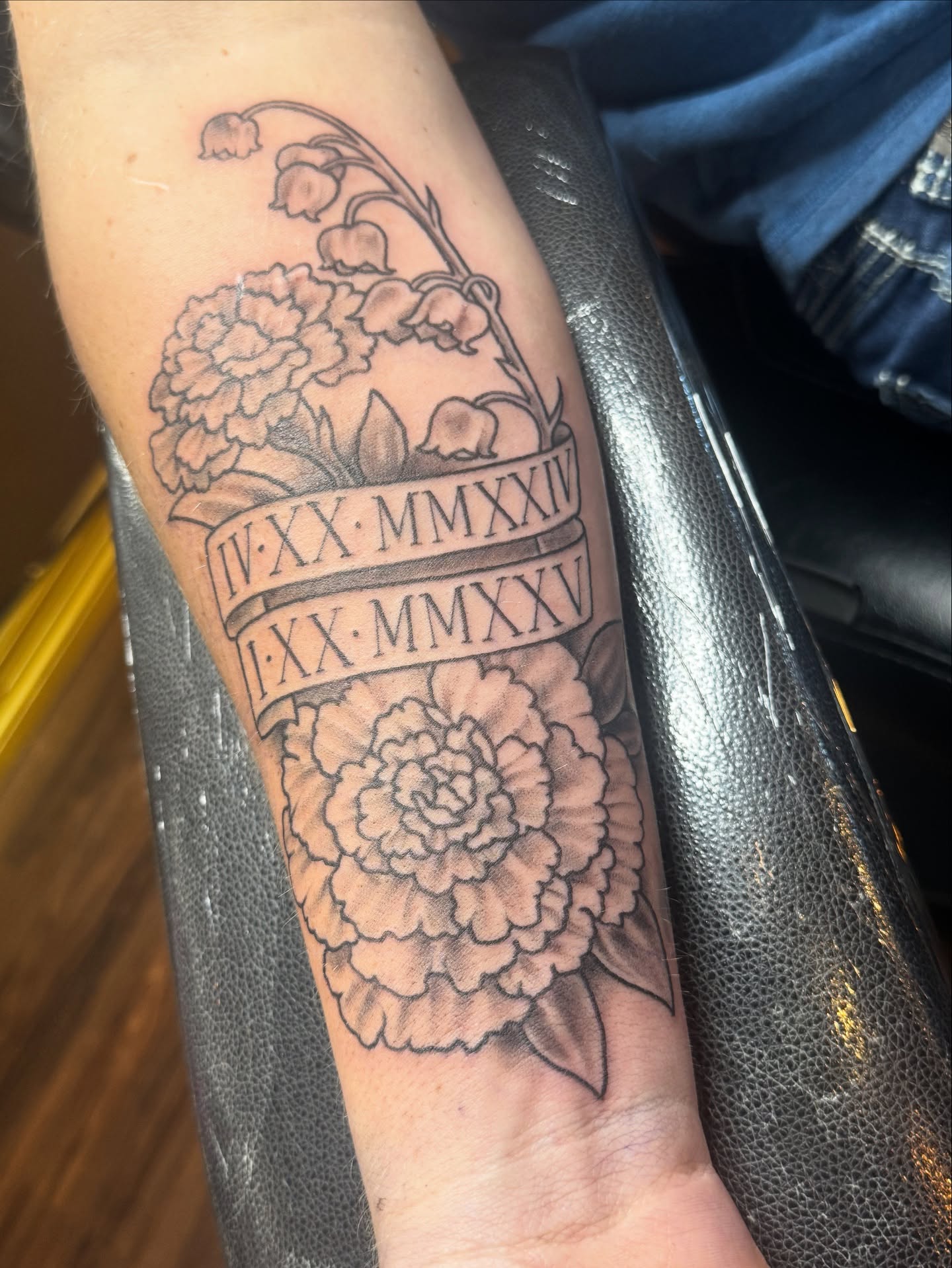 Peony and lilies of the valley black and grey tattoo on the forearm by Teagan Rachel, Millcreek, Utah