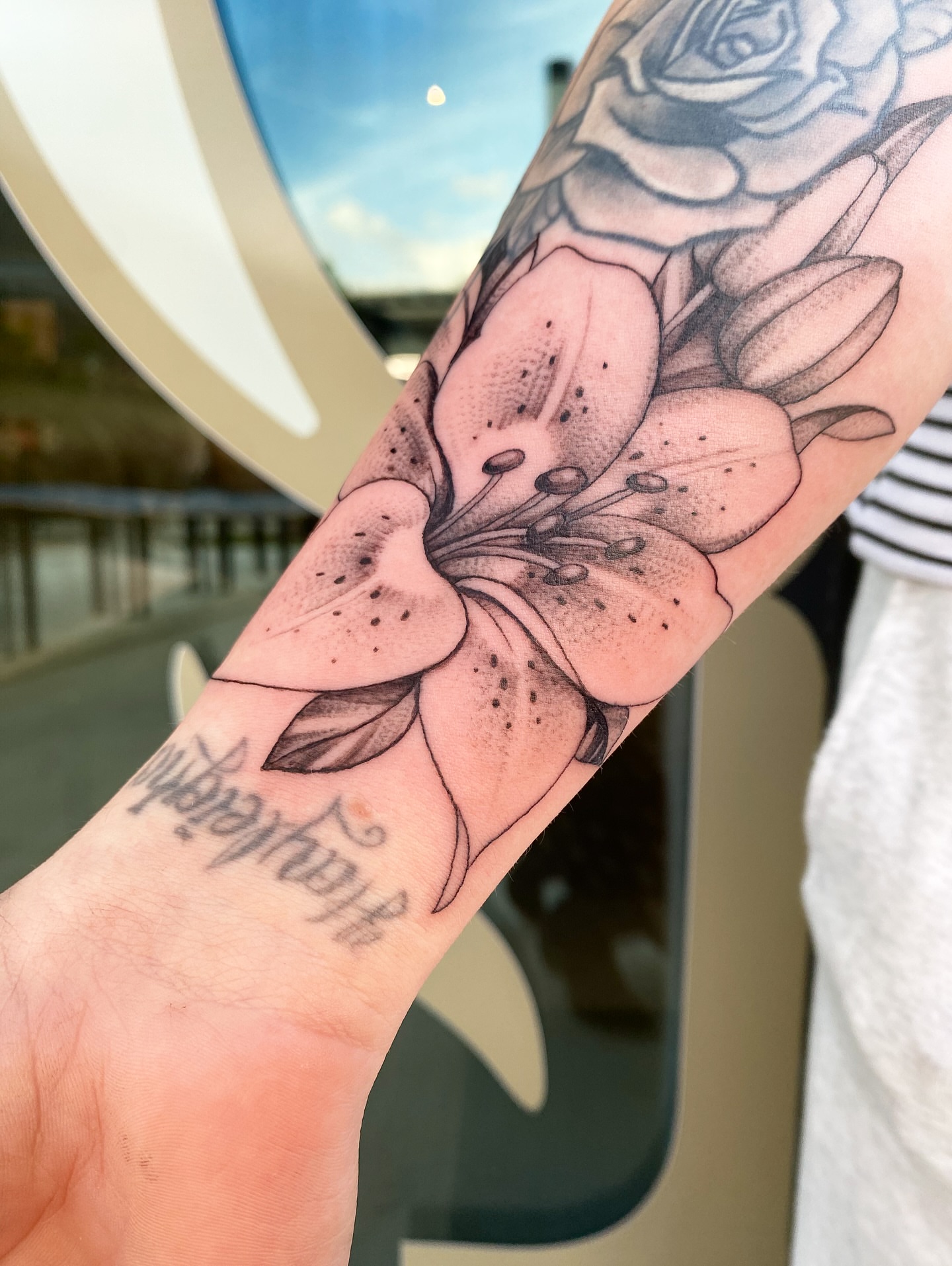 Lily dotwork tattoo on the forearm by Tattoos by Alli Wilcox