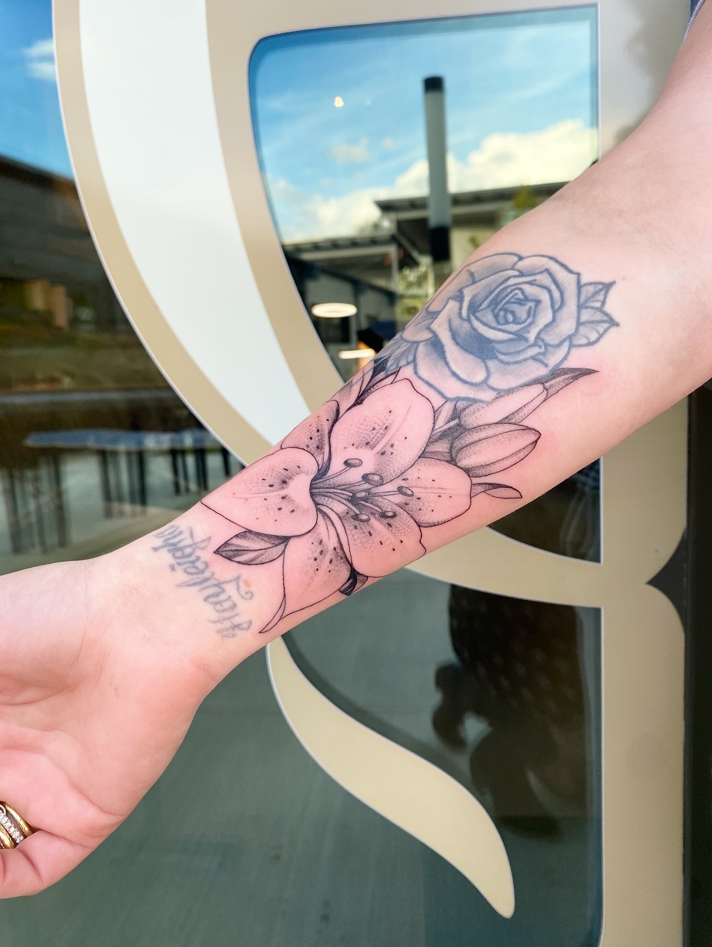 Flowers black and grey tattoo on the forearm by Tattoos by Alli Wilcox