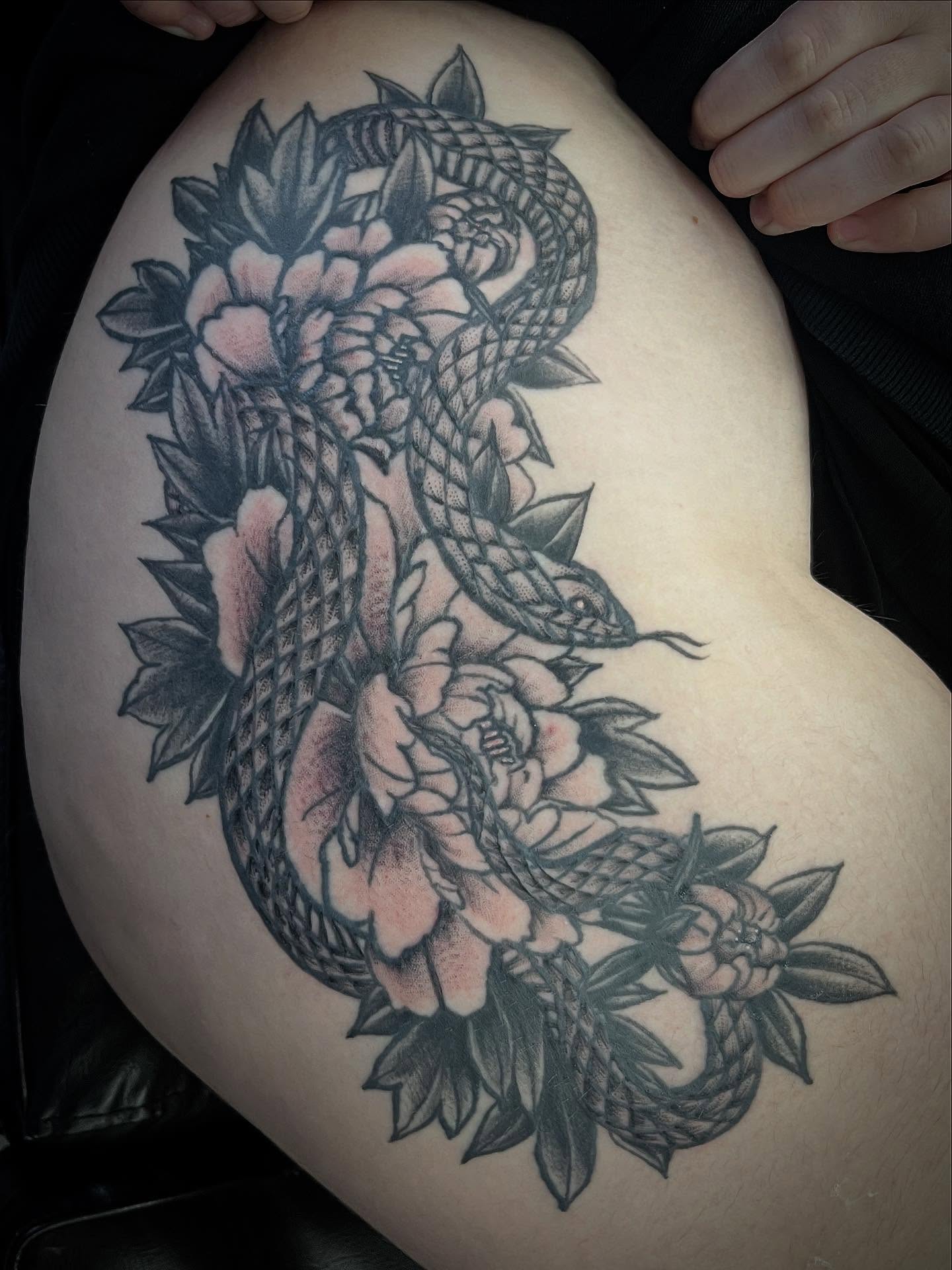 Snake and peony black and grey tattoo on the thigh by Sean Gallagher