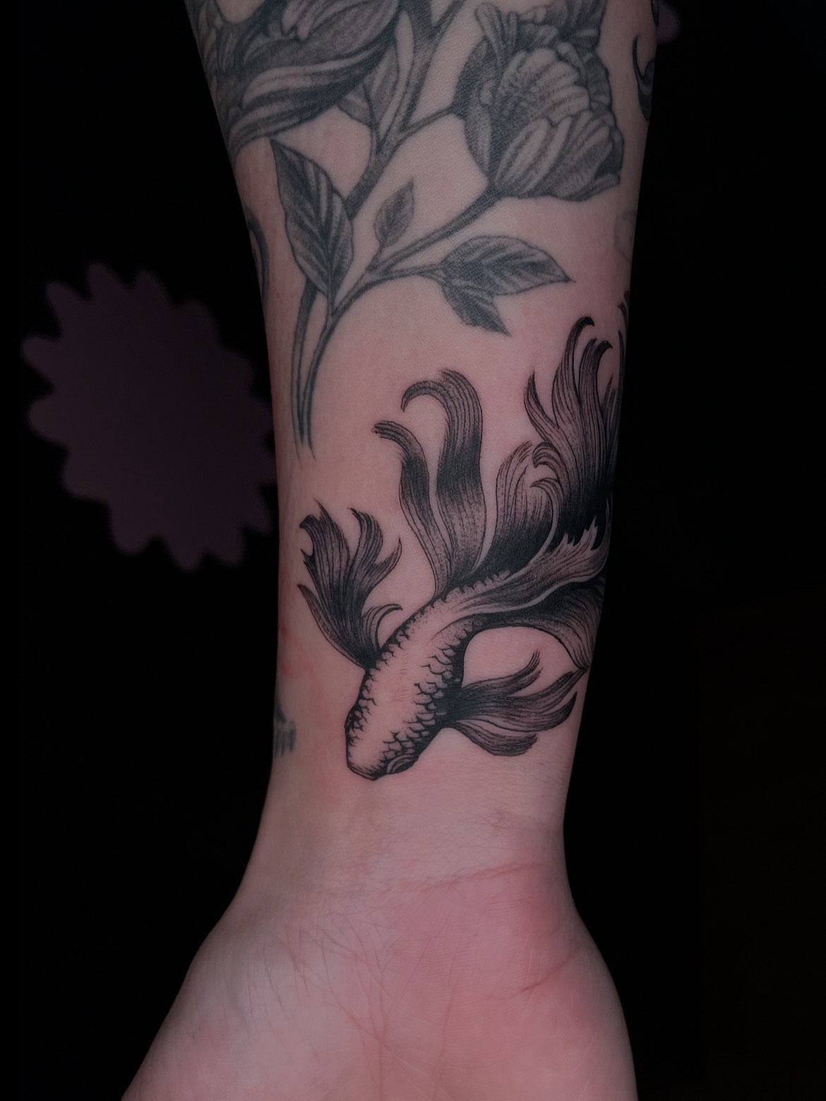 Koi fish and flowers black and grey tattoo on the forearm by Eryn, Portland, Oregon