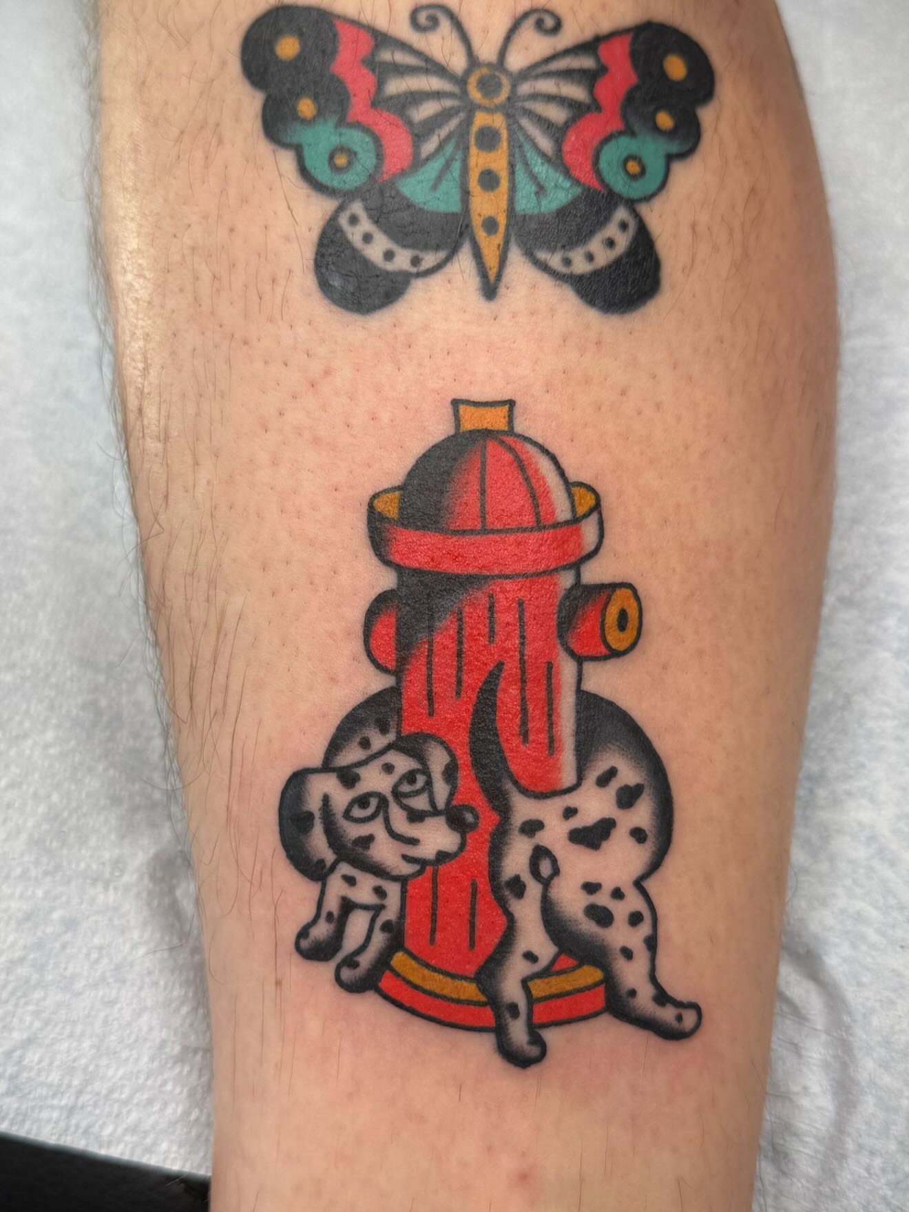 Fire hydrant and dalmatian American traditional tattoo on the forearm by kalli berry