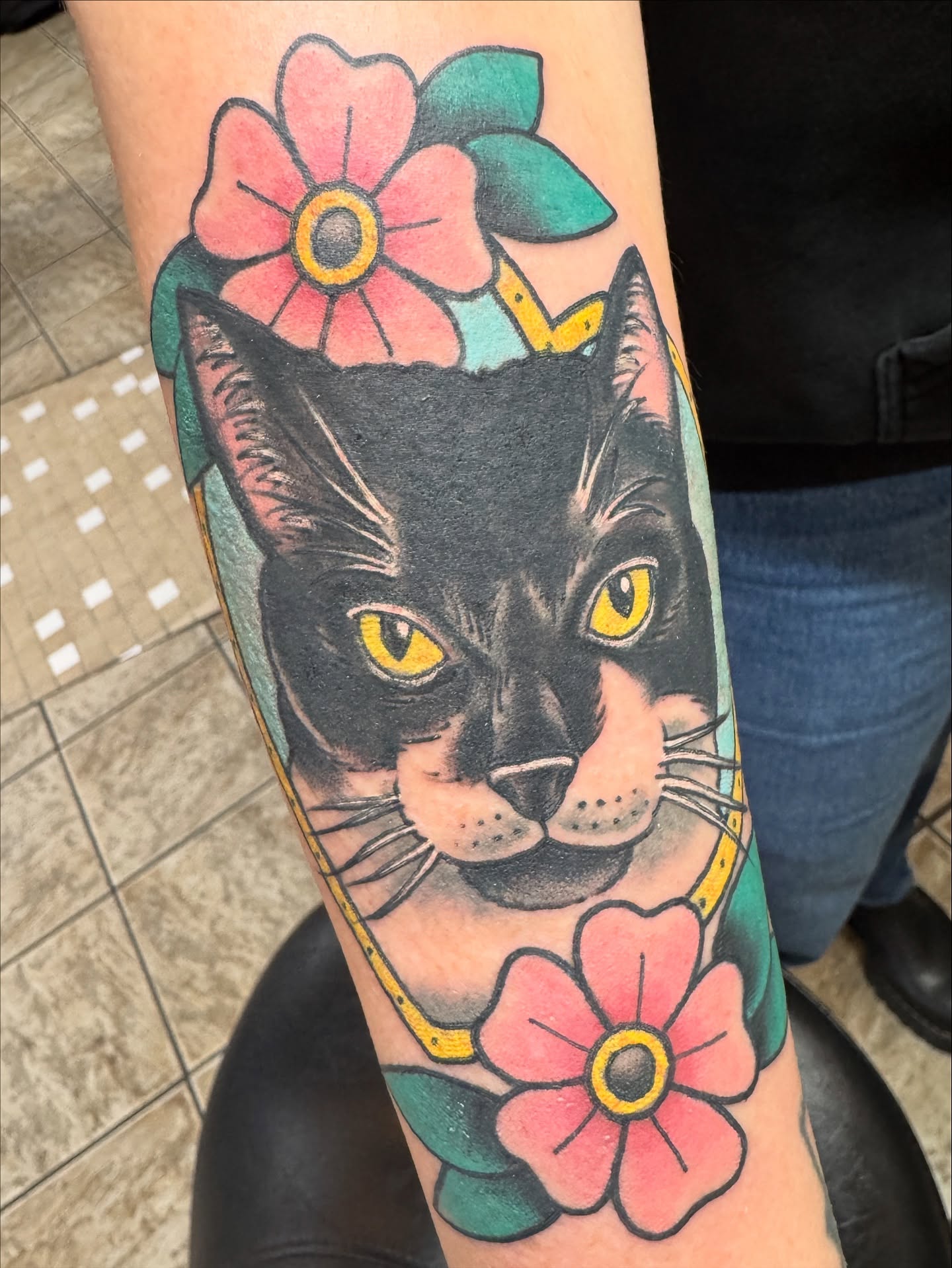 Cat with flowers American traditional tattoo on the forearm by Cary Aldridge