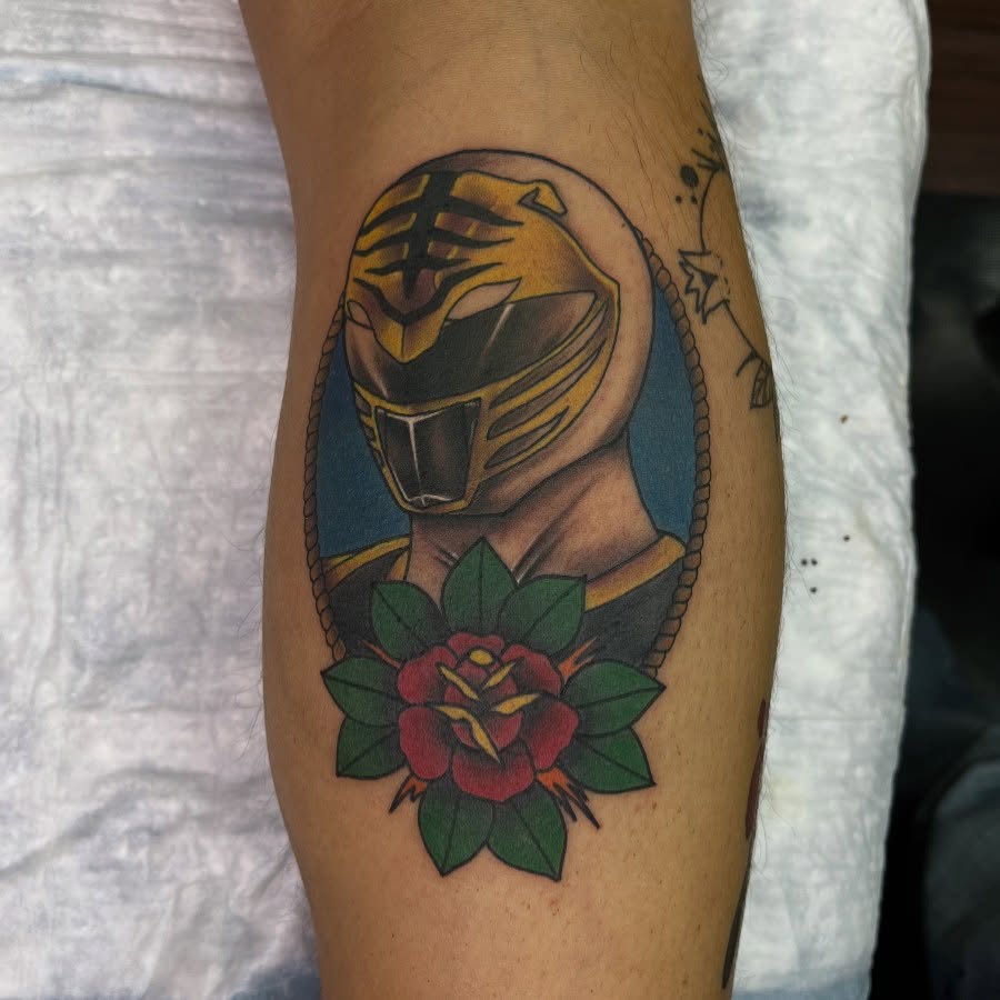Yellow ranger helmet American traditional tattoo on the forearm by Matthew Gordon