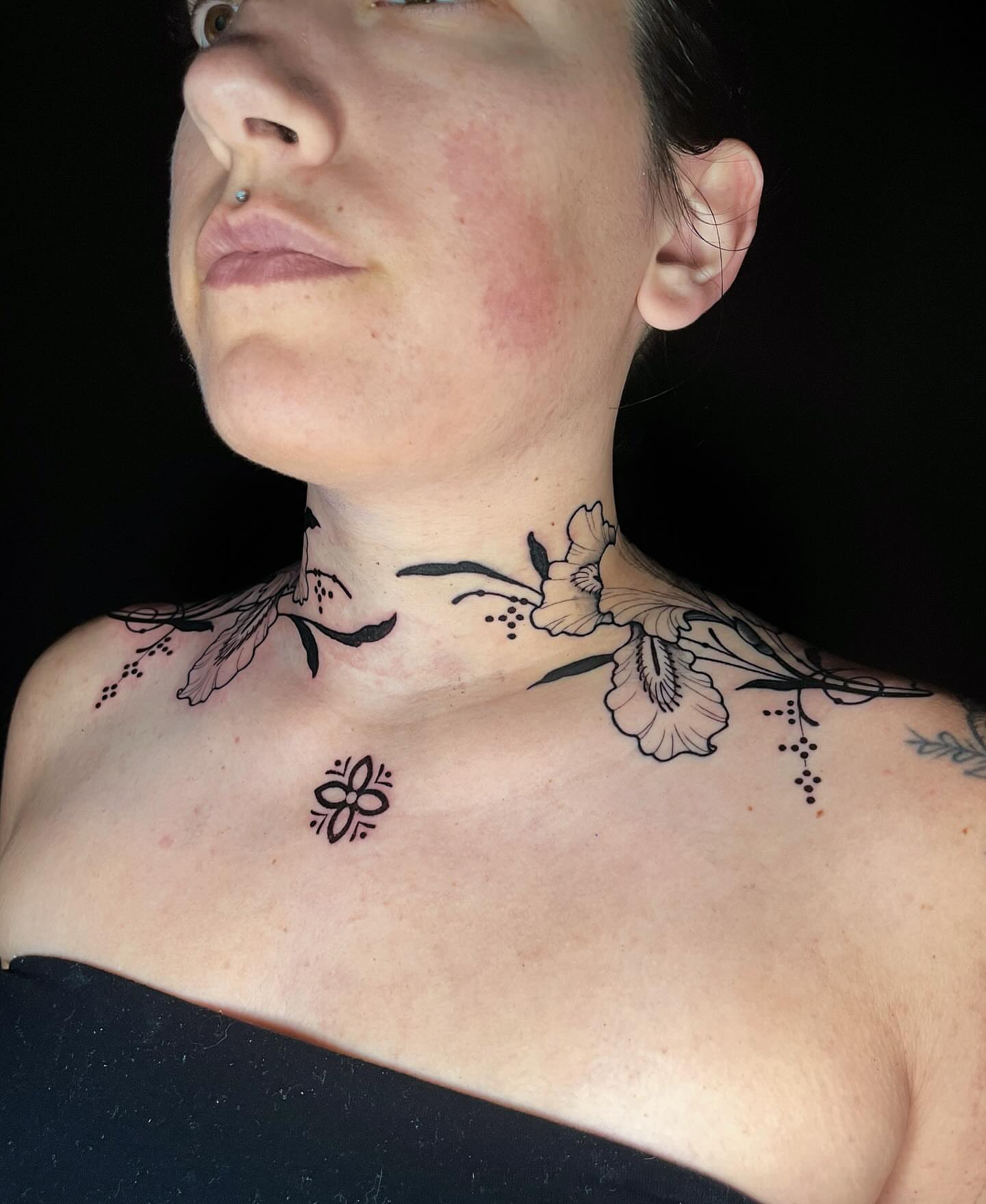 Floral black and grey tattoo on the neck by rocky love