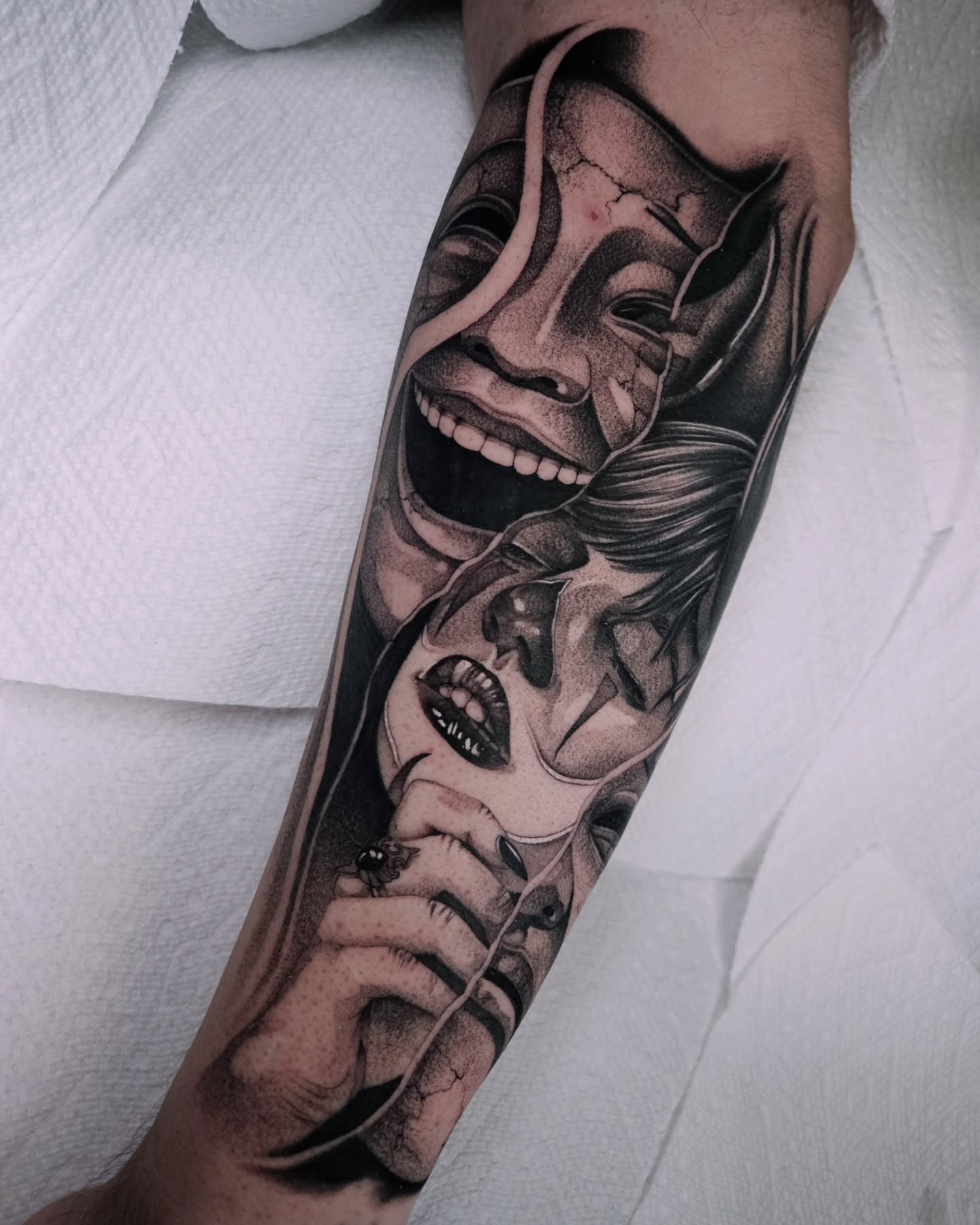Mask and woman realism tattoo on the forearm by Sabrina Wagner