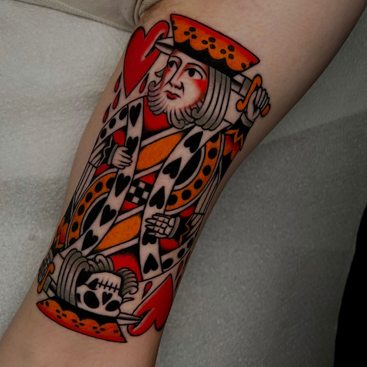 King of hearts American traditional tattoo on the forearm by Hailey Johnson