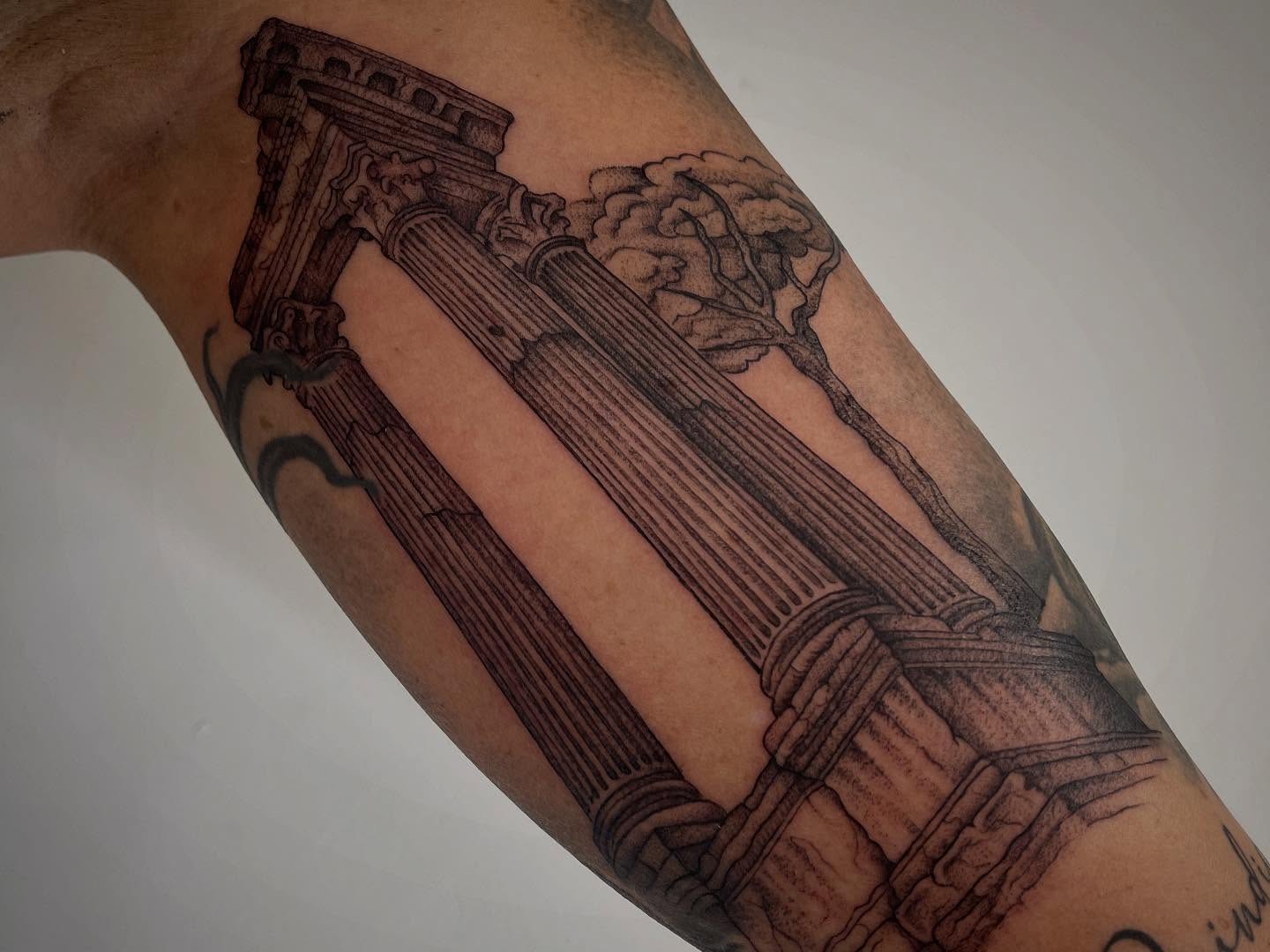 Columns and tree black and grey tattoo on the forearm by Miesha Busker