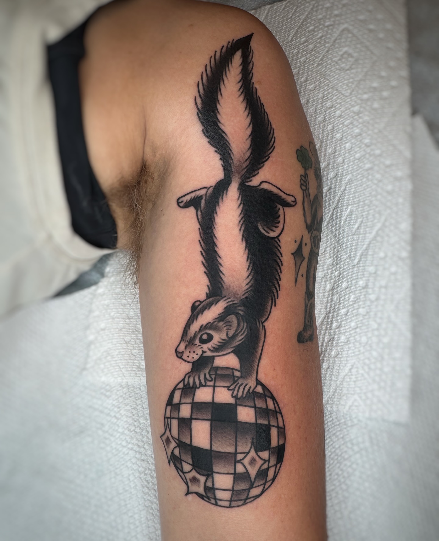 Skunk and disco ball geometric tattoo on the forearm by Cori James Tattoo Artist