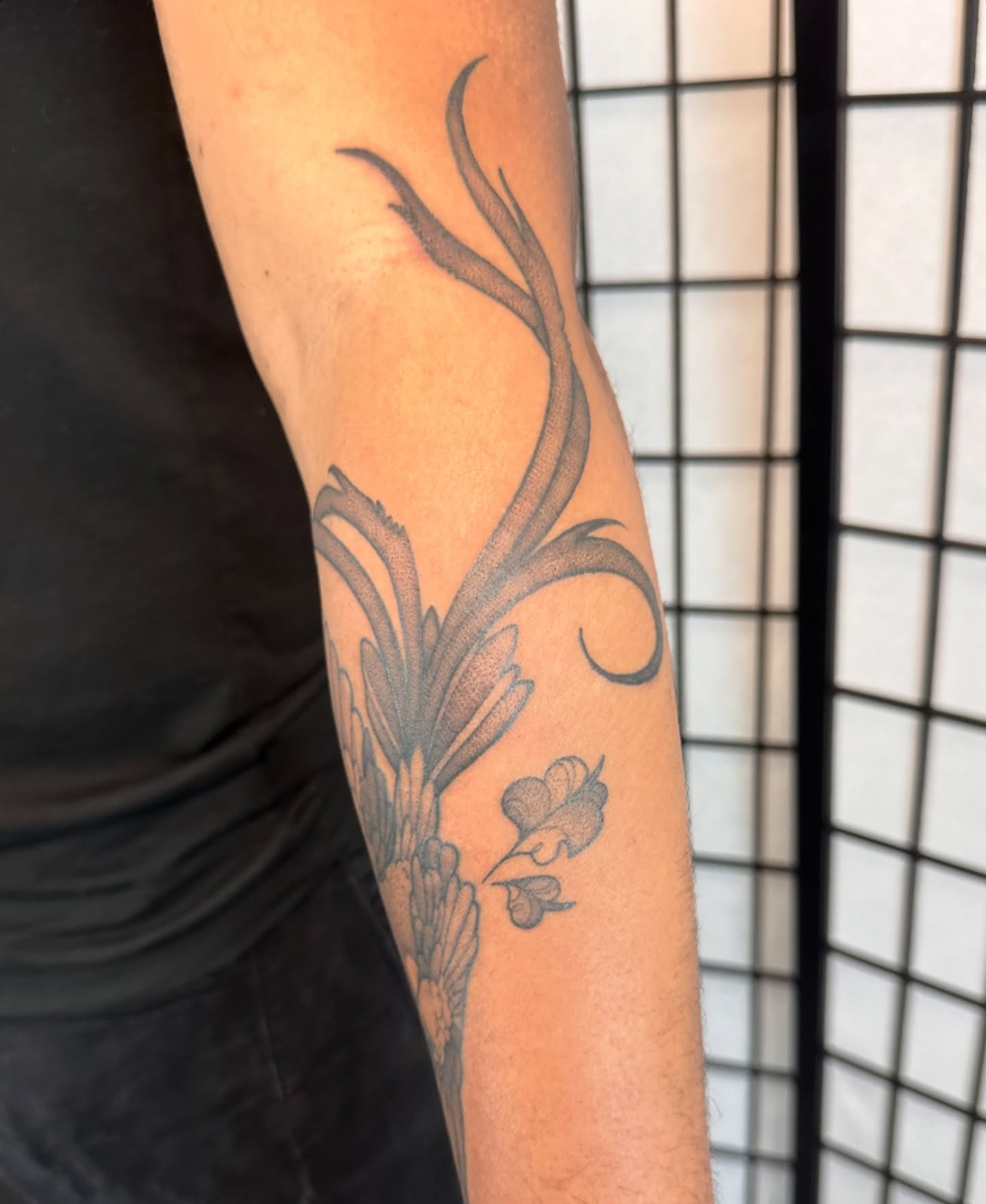 Flower and leaves black and grey tattoo on the forearm by TATTOOLIZARD (James)