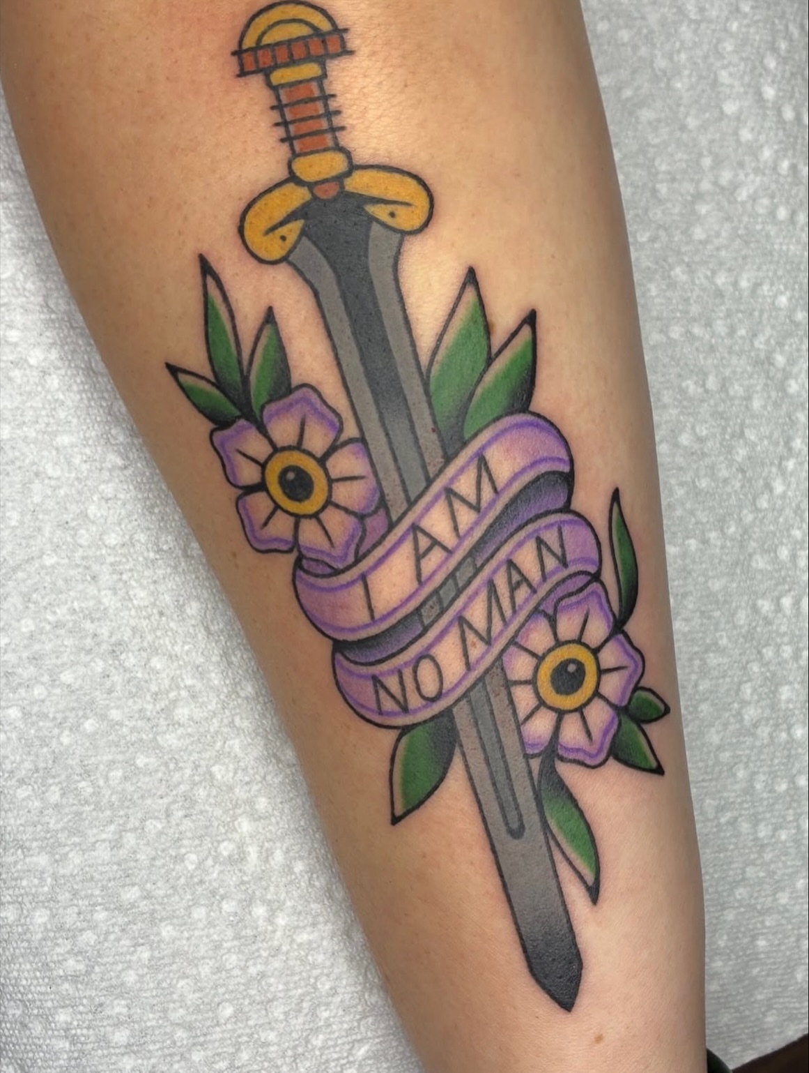 Sword and ribbon American traditional tattoo on the forearm by Lance 🦈