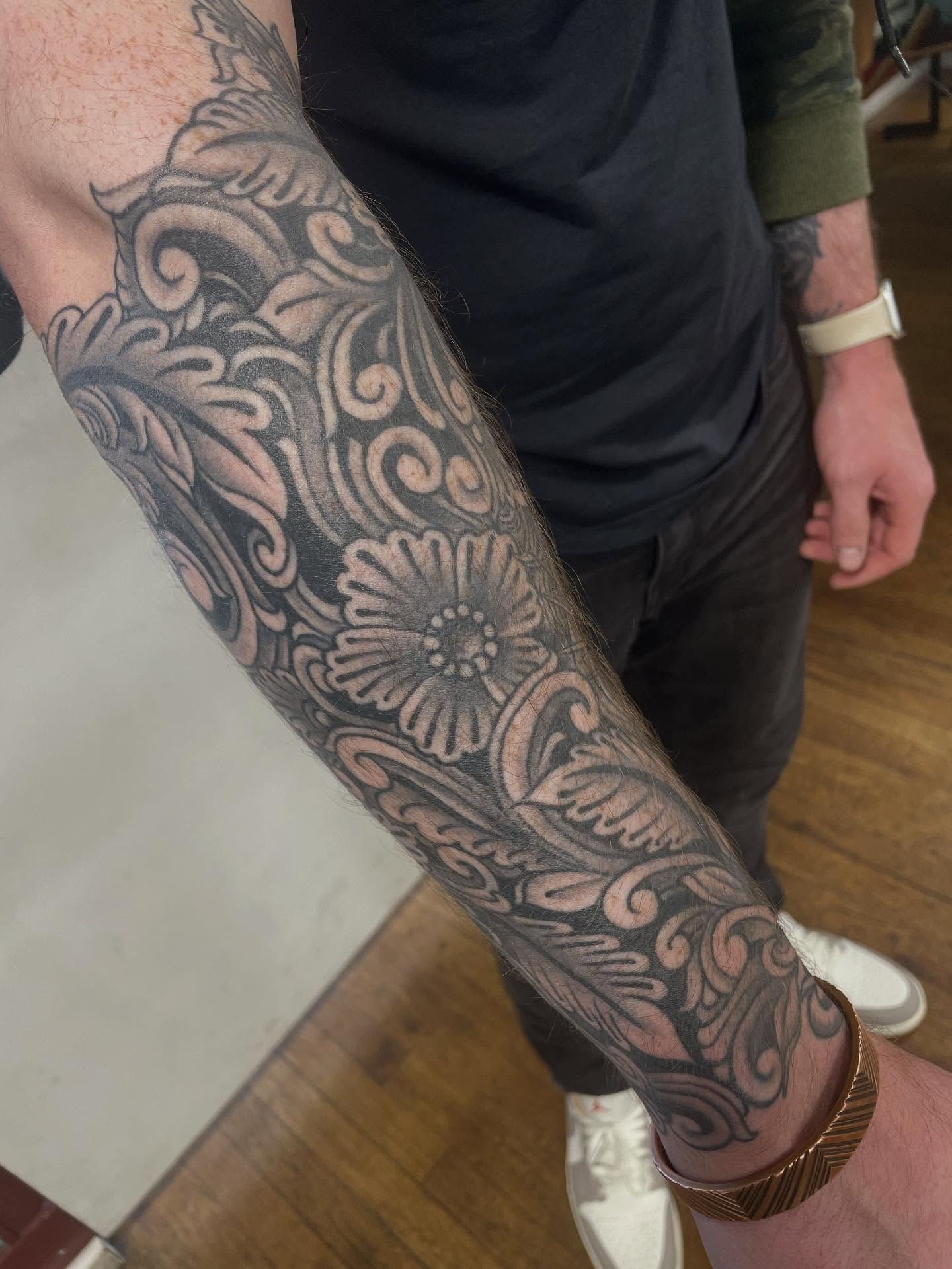 Floral pattern black and grey tattoo on the forearm by Haley McMahon