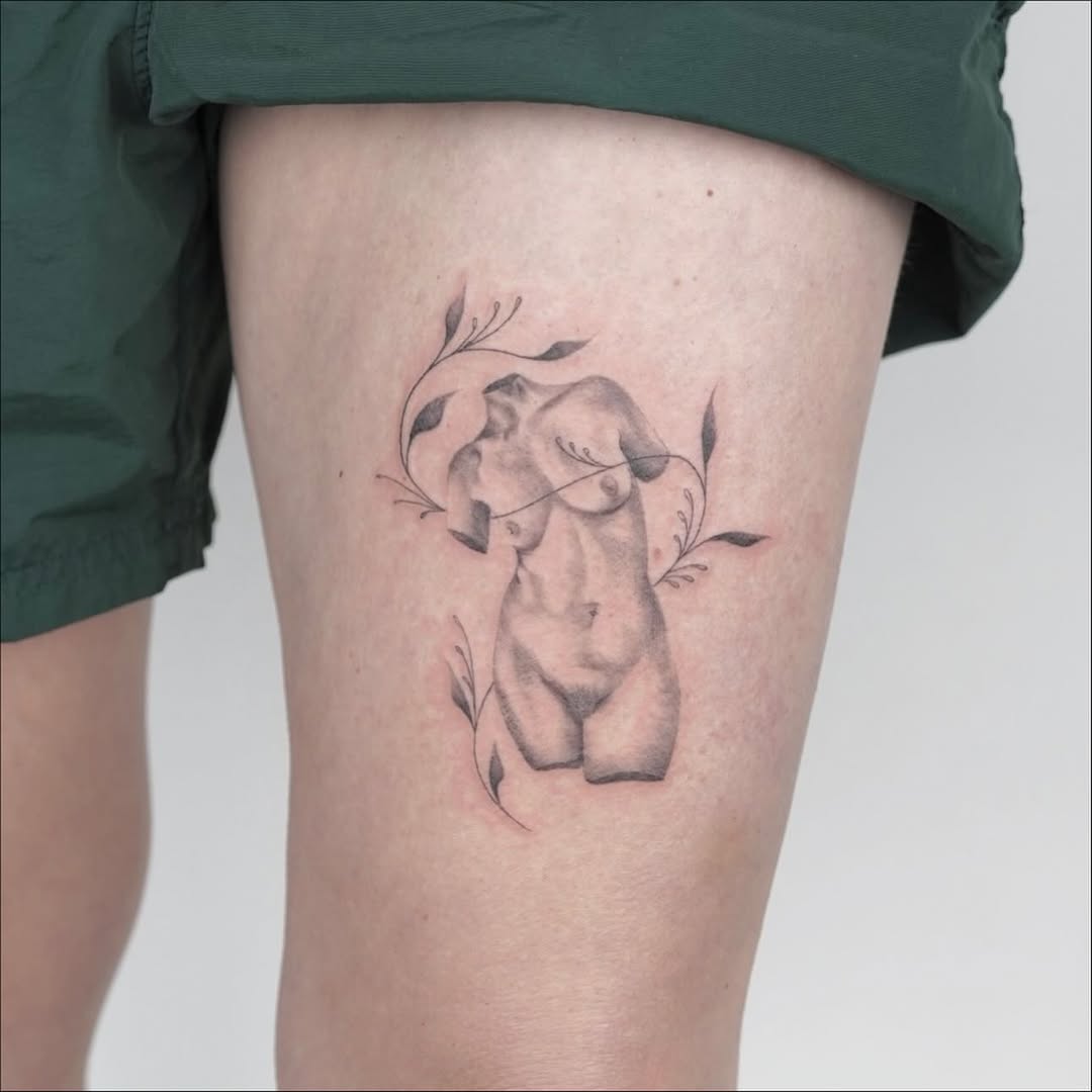 Sculptural torso with leaves sketch tattoo on the thigh by Julia