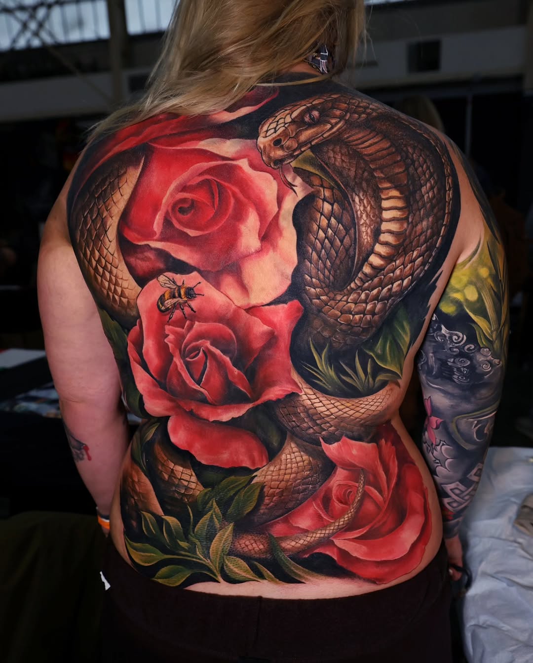 Cobra and roses neo-traditional tattoo on the back by Marek Pawlik