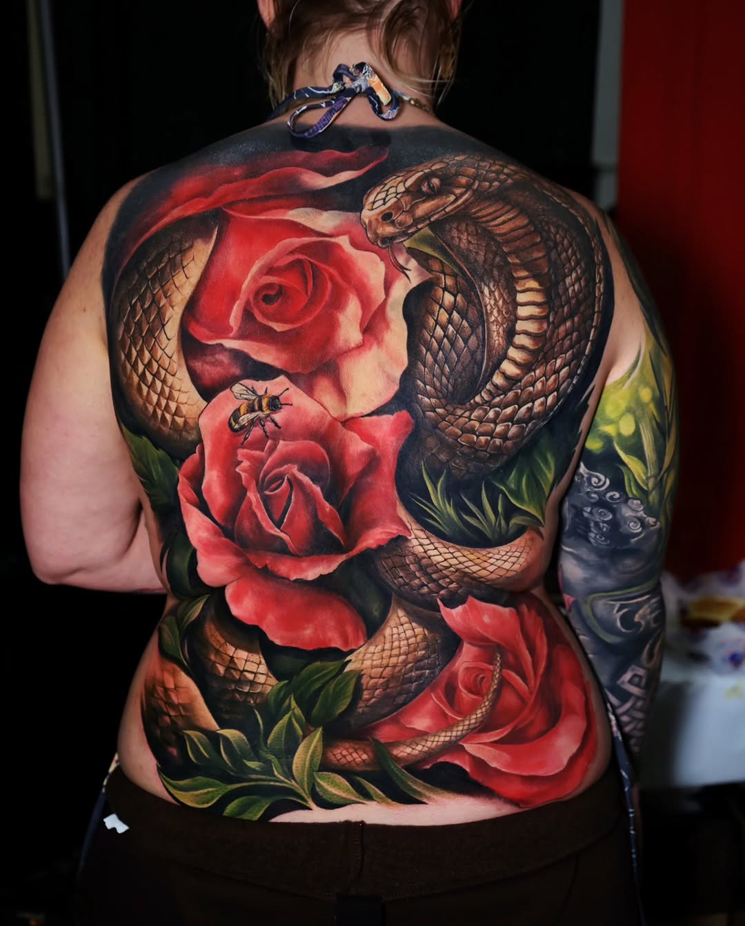 Cobra snake and roses neo-traditional tattoo on the back by Marek Pawlik
