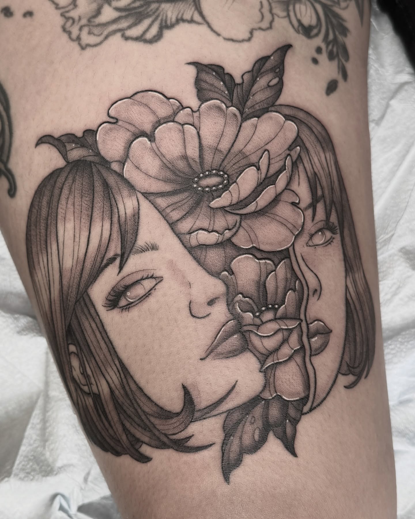 Floral portrait realism tattoo on the thigh by Hannah May, La Mesa, California