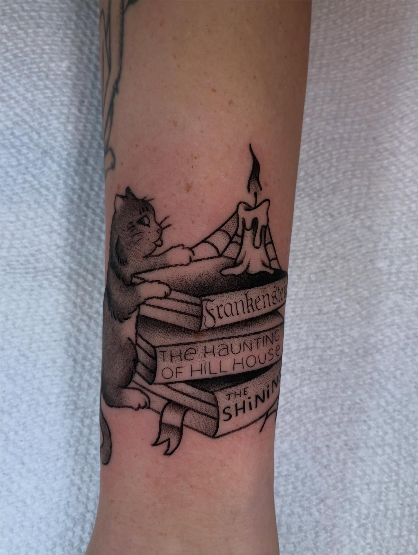 Cat reading books realism tattoo on the forearm by ๐๐ช๐๐ซ๐ก๐ ๐๐ฏ๐ถ๐ฉ๐