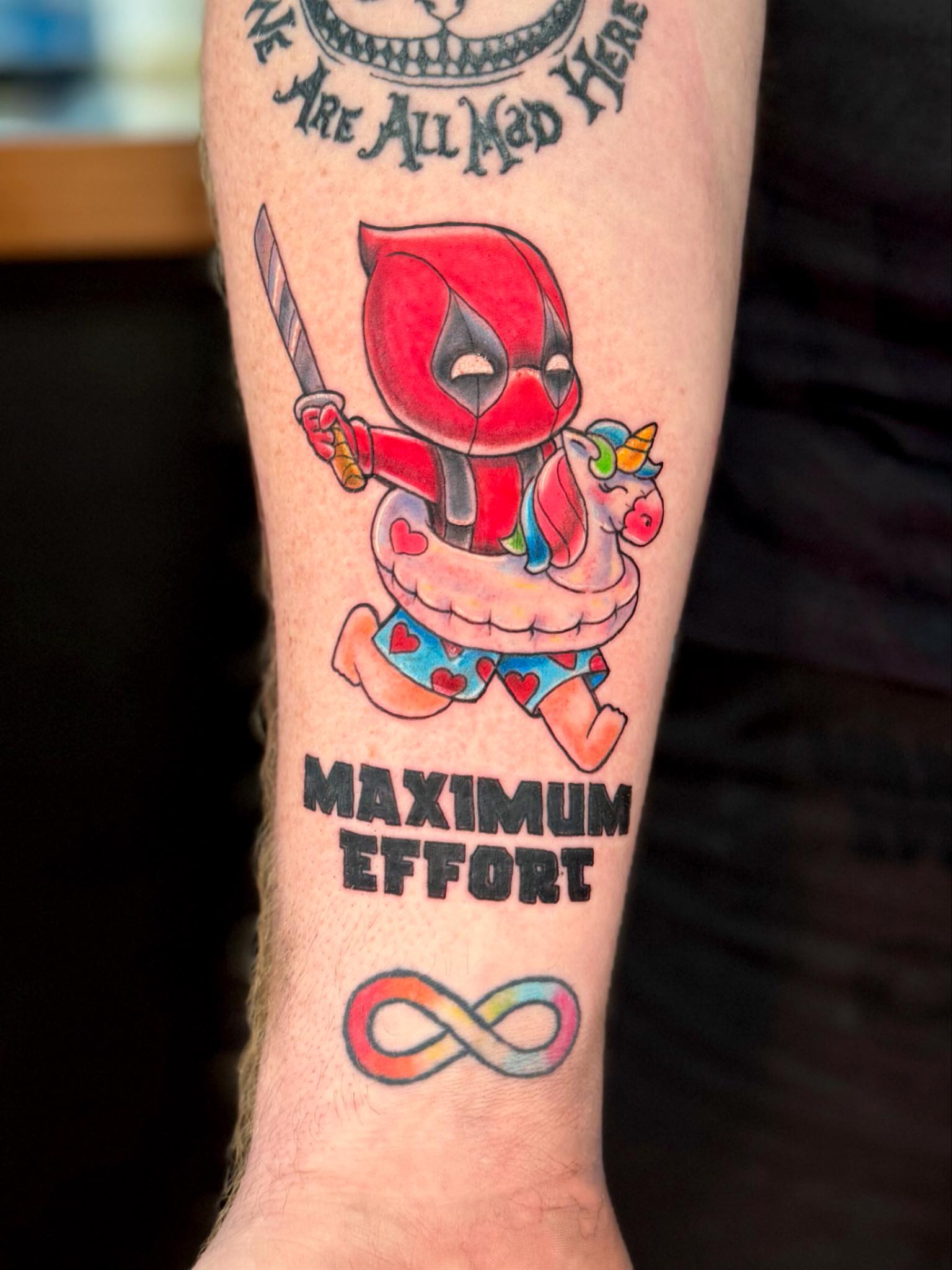 Deadpool on unicorn new school tattoo on the forearm by Breanna B