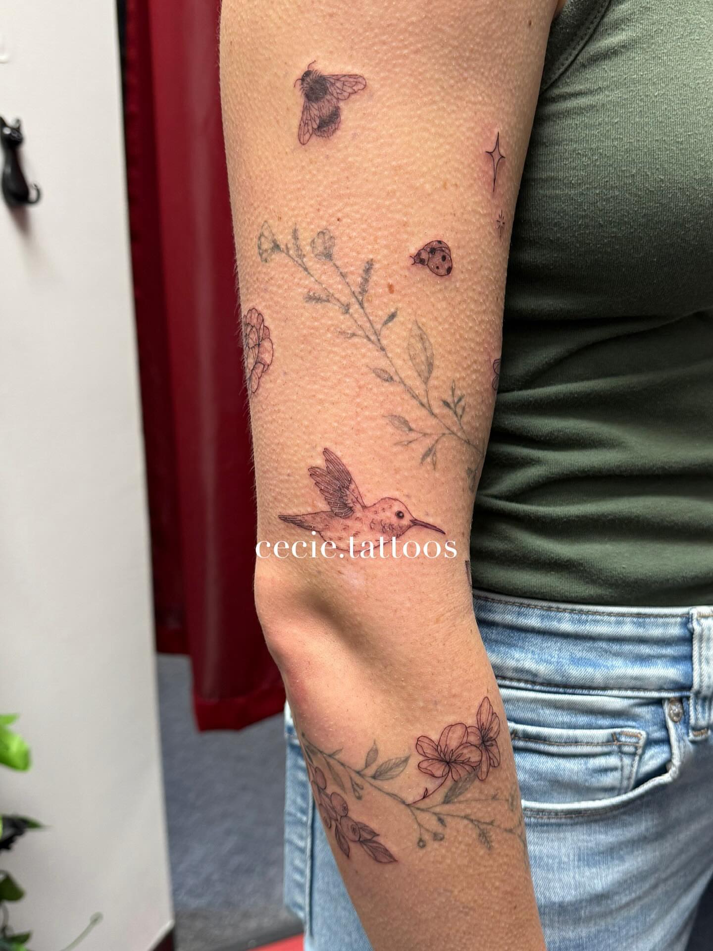 Hummingbird and floral fine line tattoo on the forearm by cecie moua