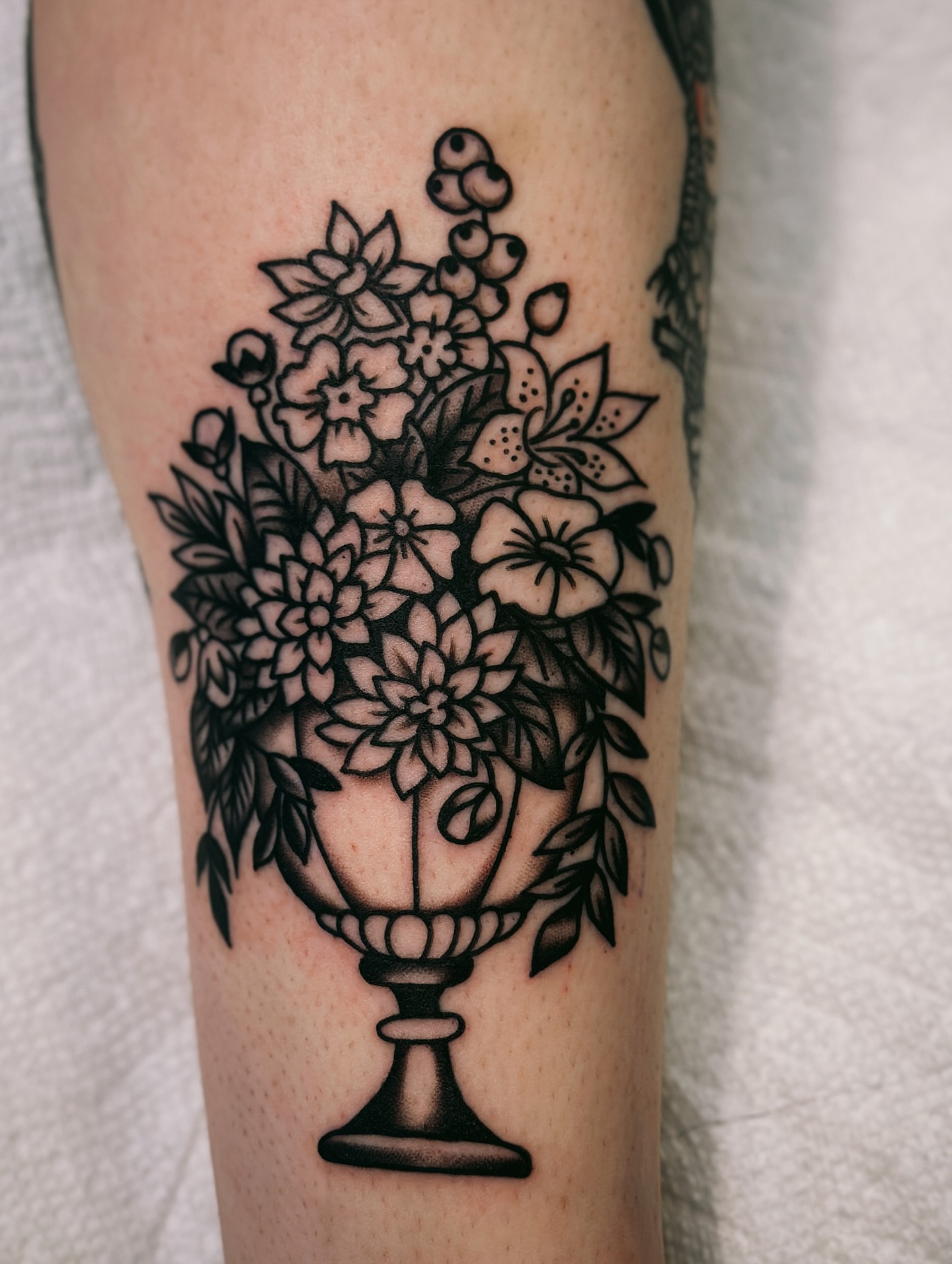 Flower bouquet American traditional tattoo on the forearm by Holly Ellis, San Francisco, California