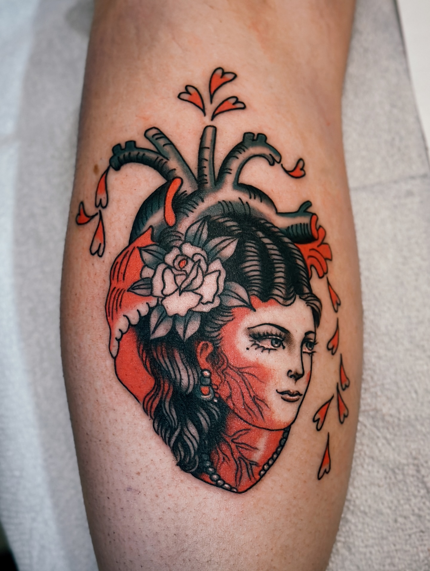 Heart with woman's face American traditional tattoo on the forearm by Holly Ellis, San Francisco, California