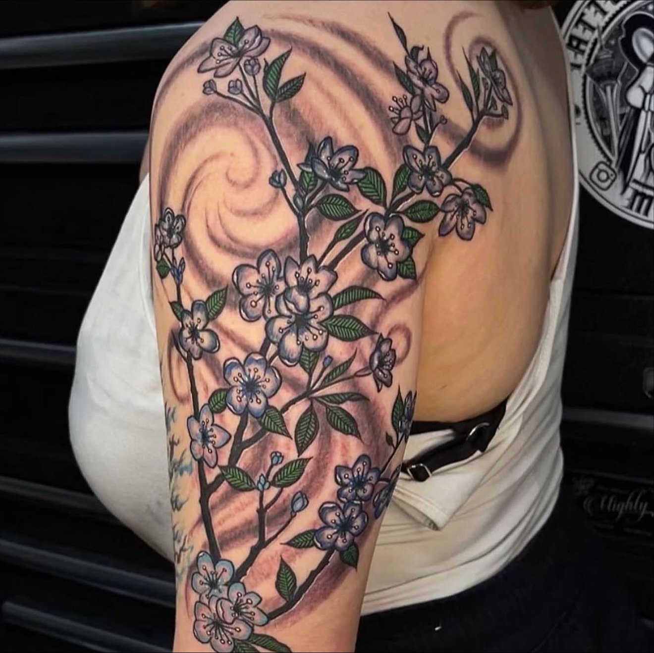 Cherry blossom new school tattoo on the upper arm by Gary Chase