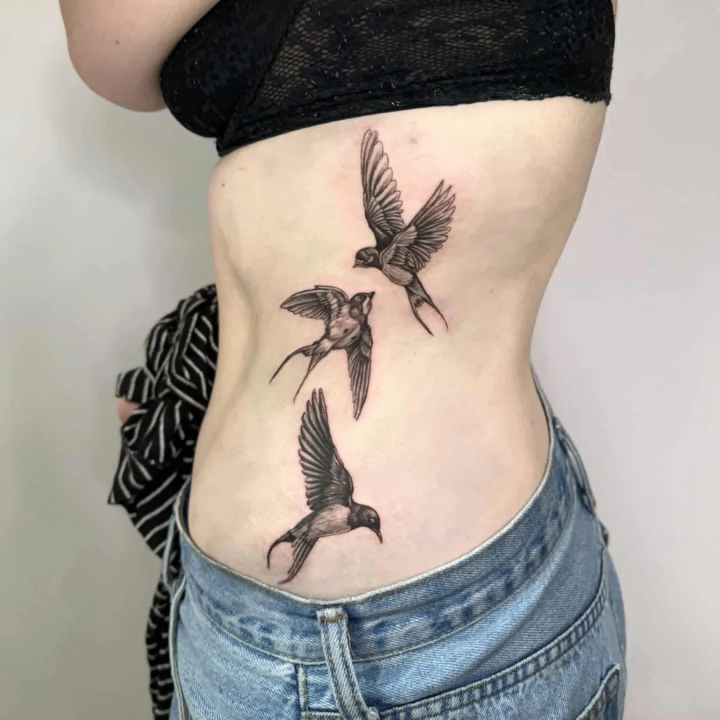 Swallows black and grey tattoo on the ribs by Joc