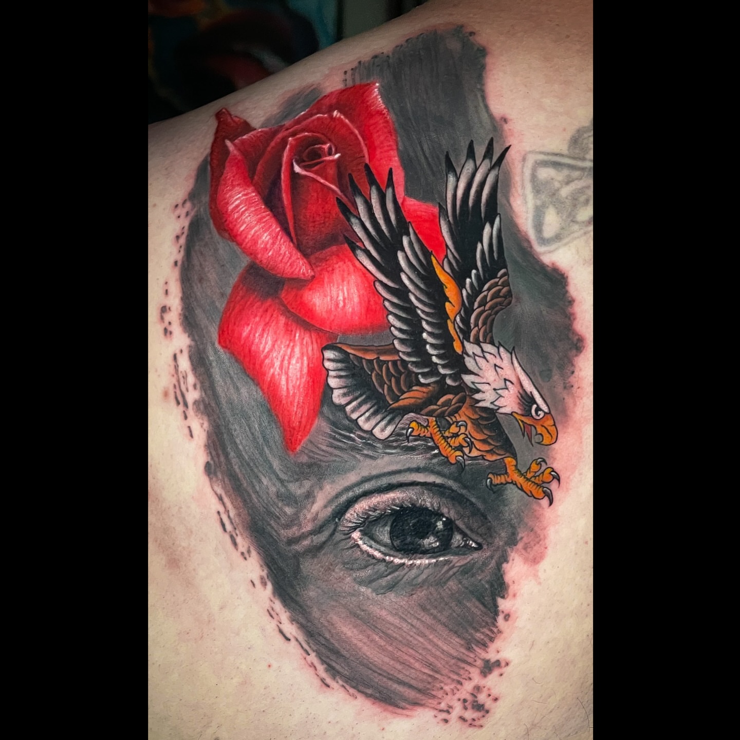 Eagle and rose realism tattoo on the shoulder by Brian Ulibarri