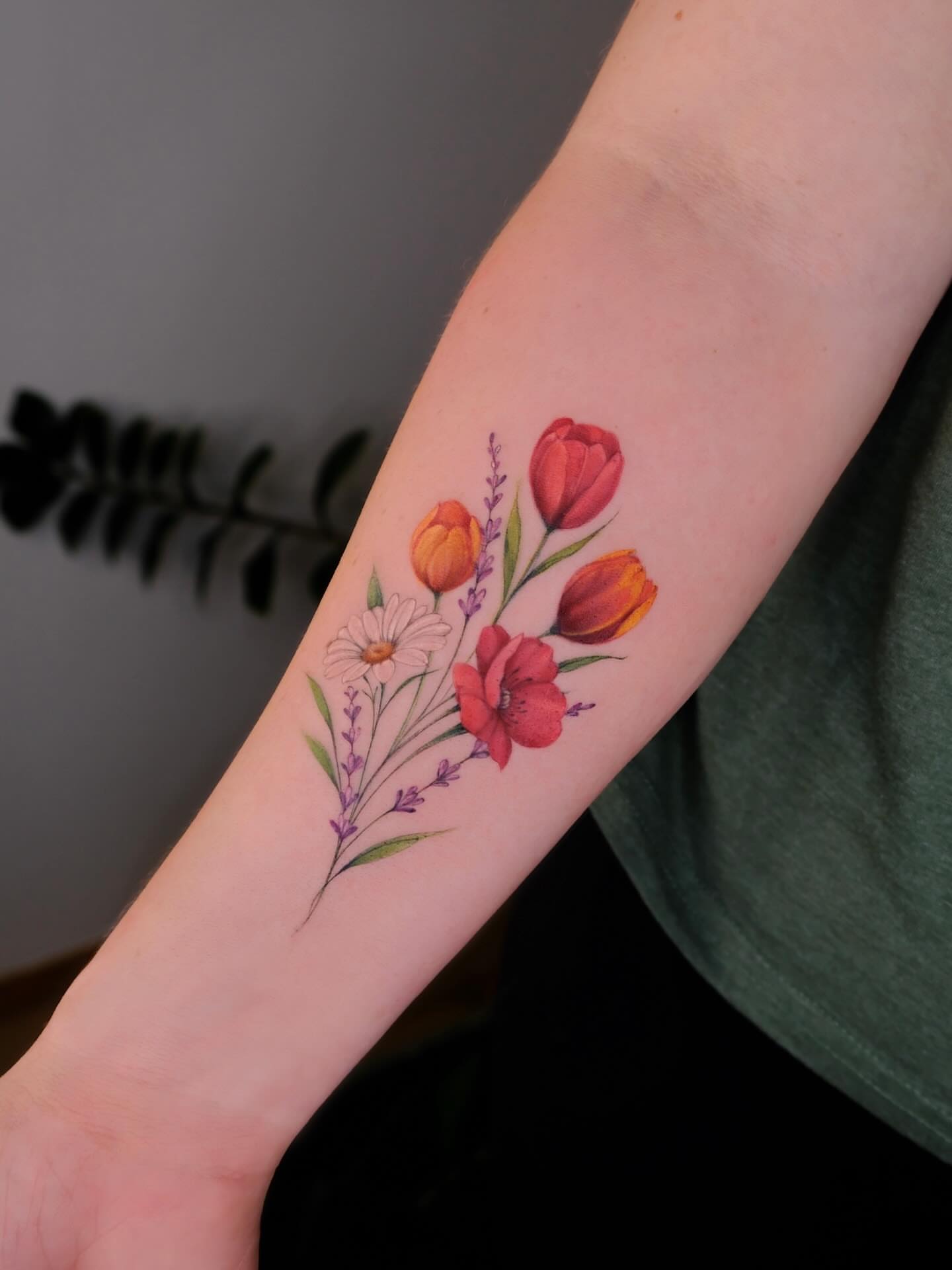 Floral arrangement watercolor tattoo on the forearm by Thin line and color TATTOO.