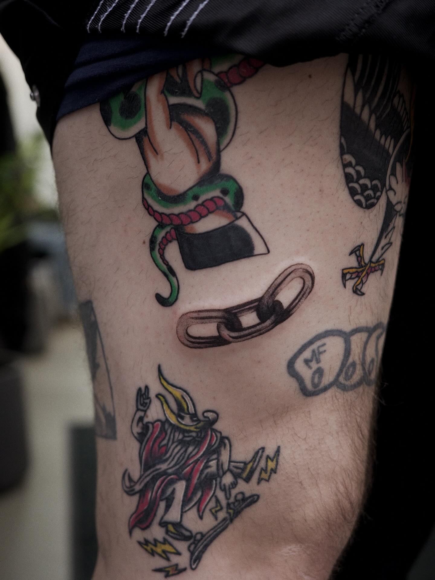 Snake and chain American traditional tattoo on the thigh by It’s ya girl, KB